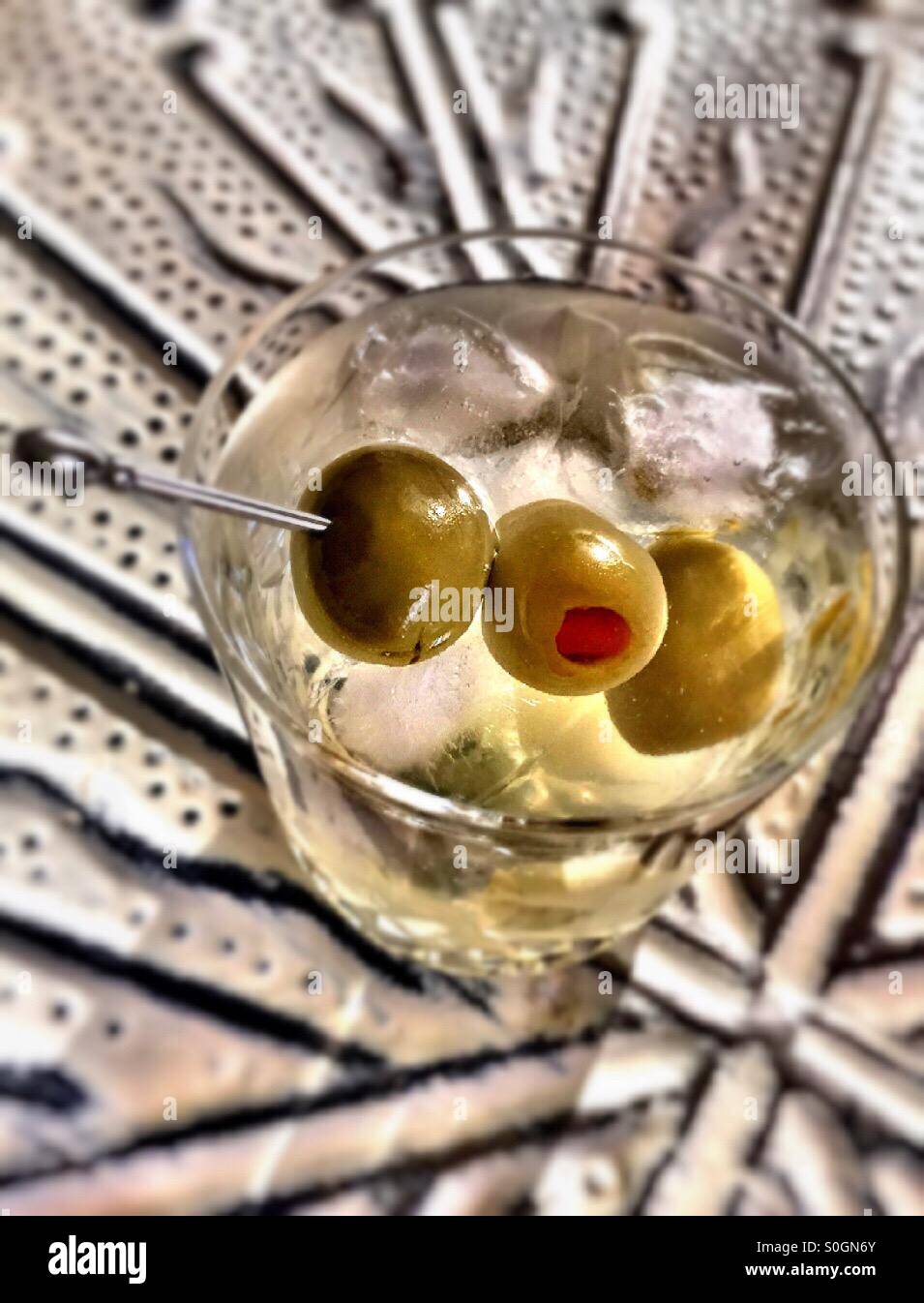 Martini on the rocks with three olives in a crystal glass tumbler - Smartphone Captured Stock Image