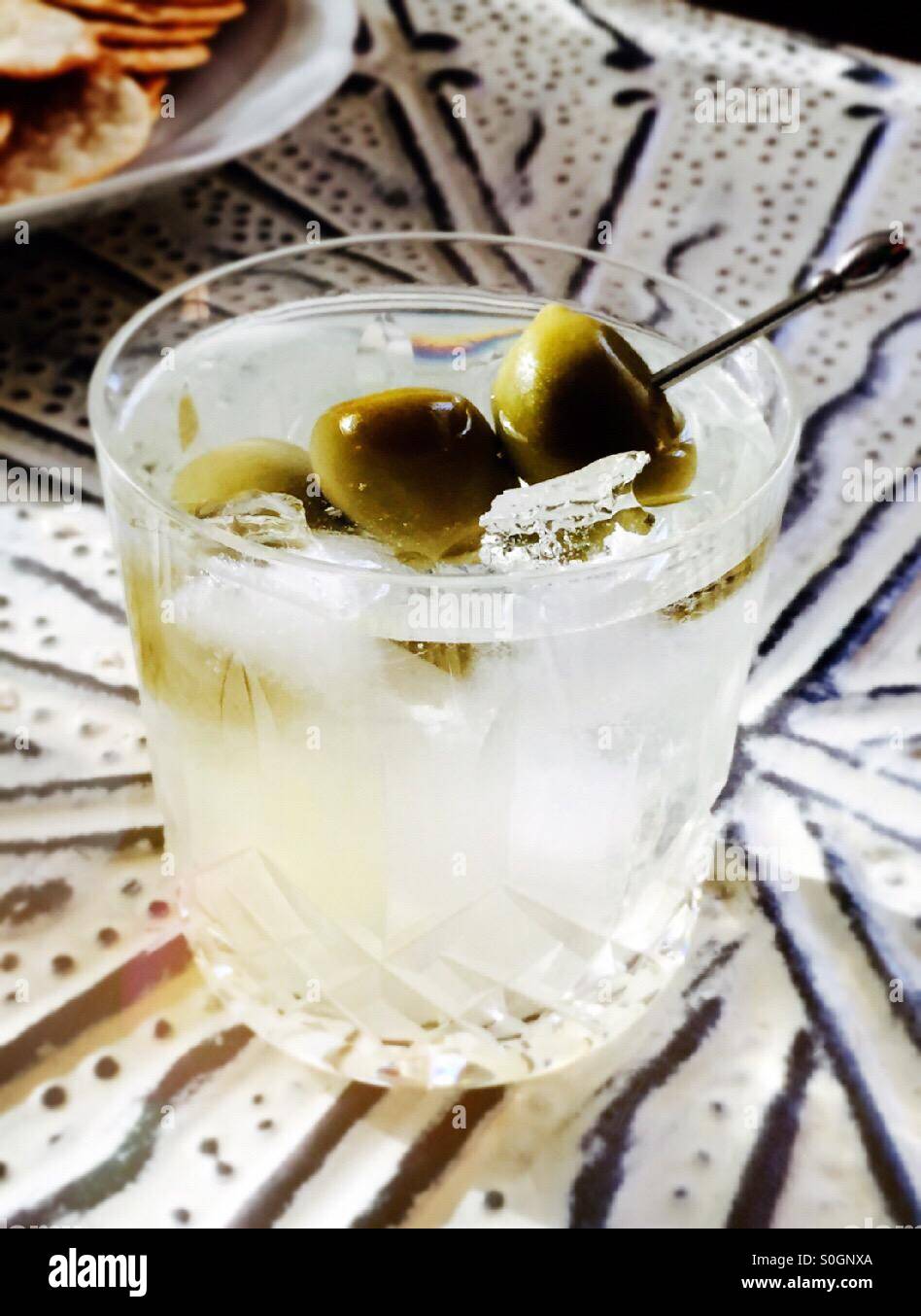 Martini on the rocks with olives in crystal glass tumbler - Smartphone Captured Stock Image