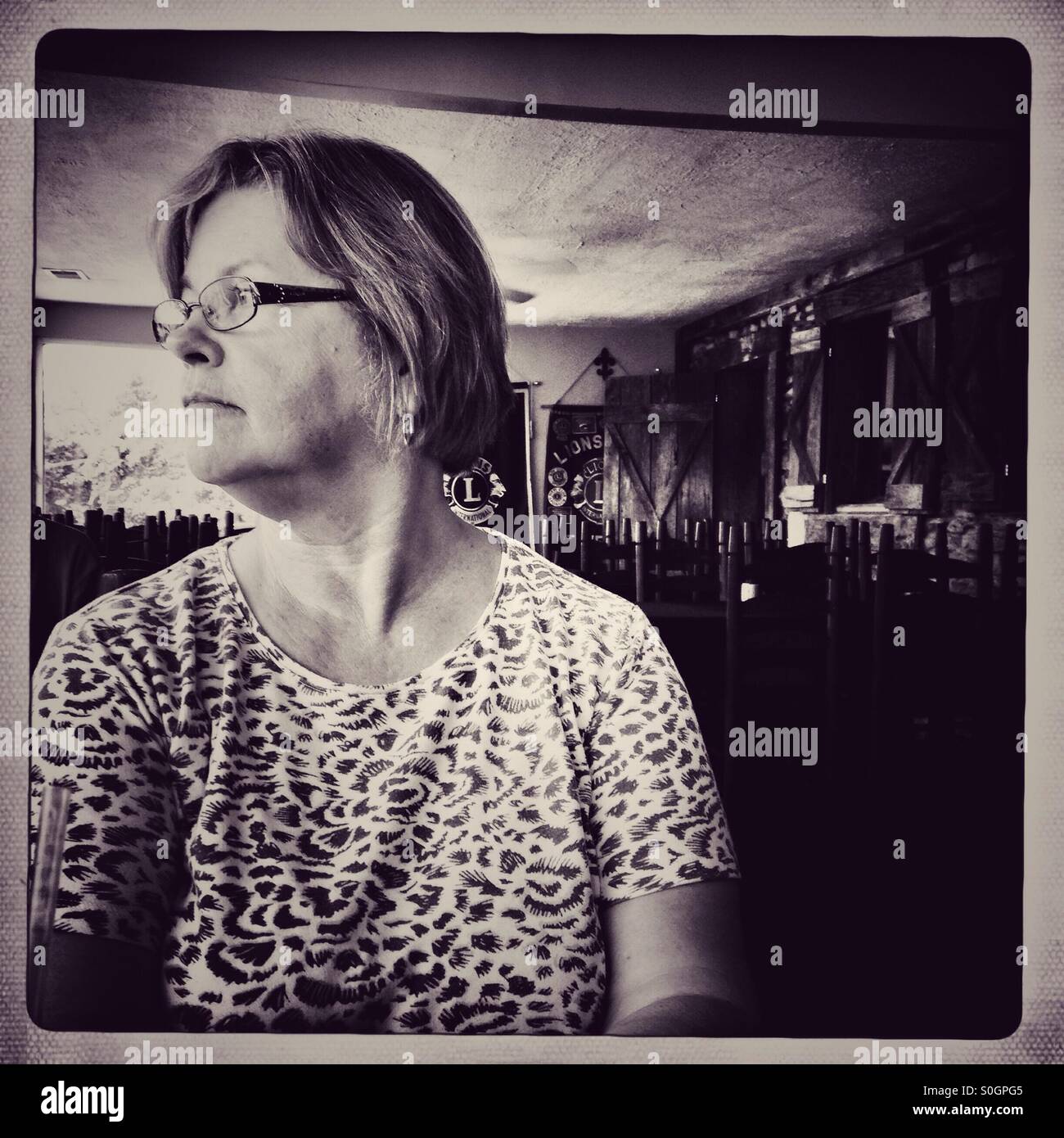 A woman waiting for food at a restaurant (b/w) - Smartphone Captured Stock Image