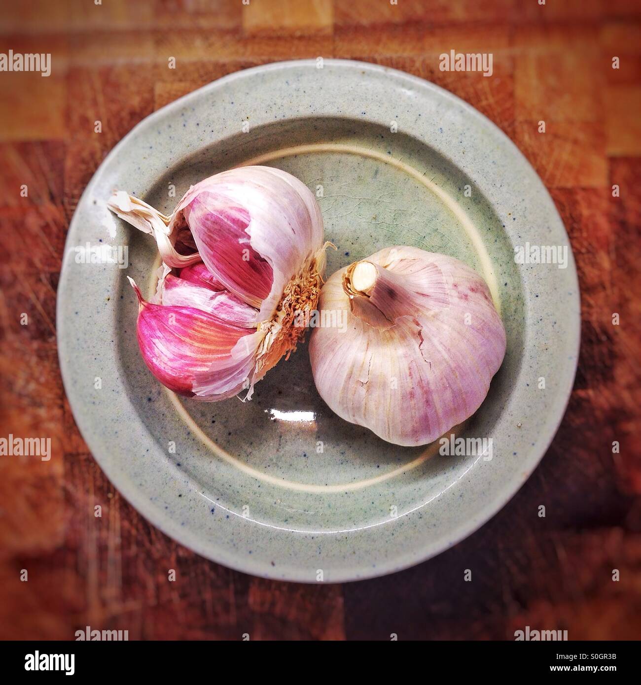 Garlic bulbs in a dish Stock Photo