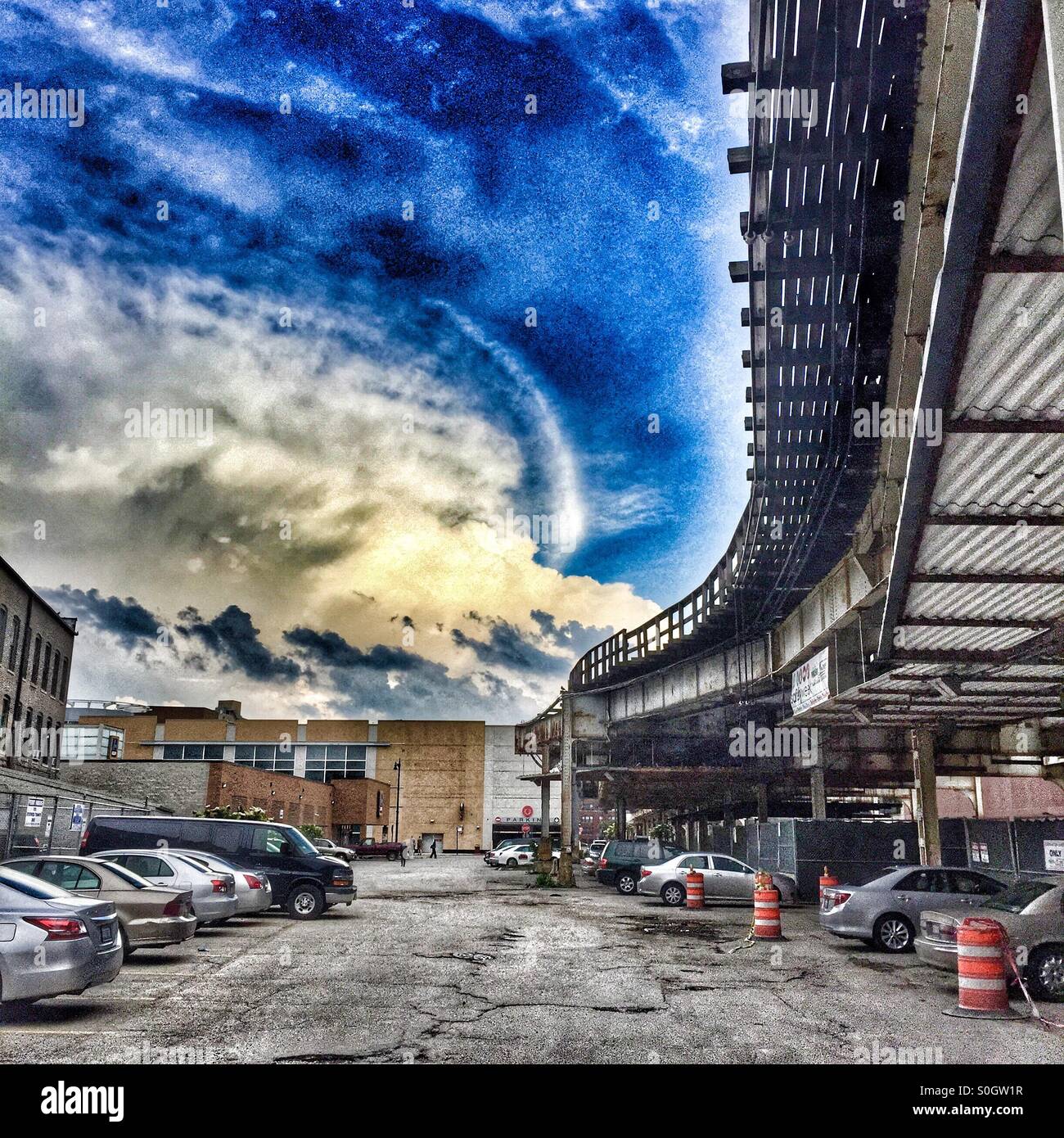 Train tracks and a parking lot with a dramatic sky as a backdrop Stock