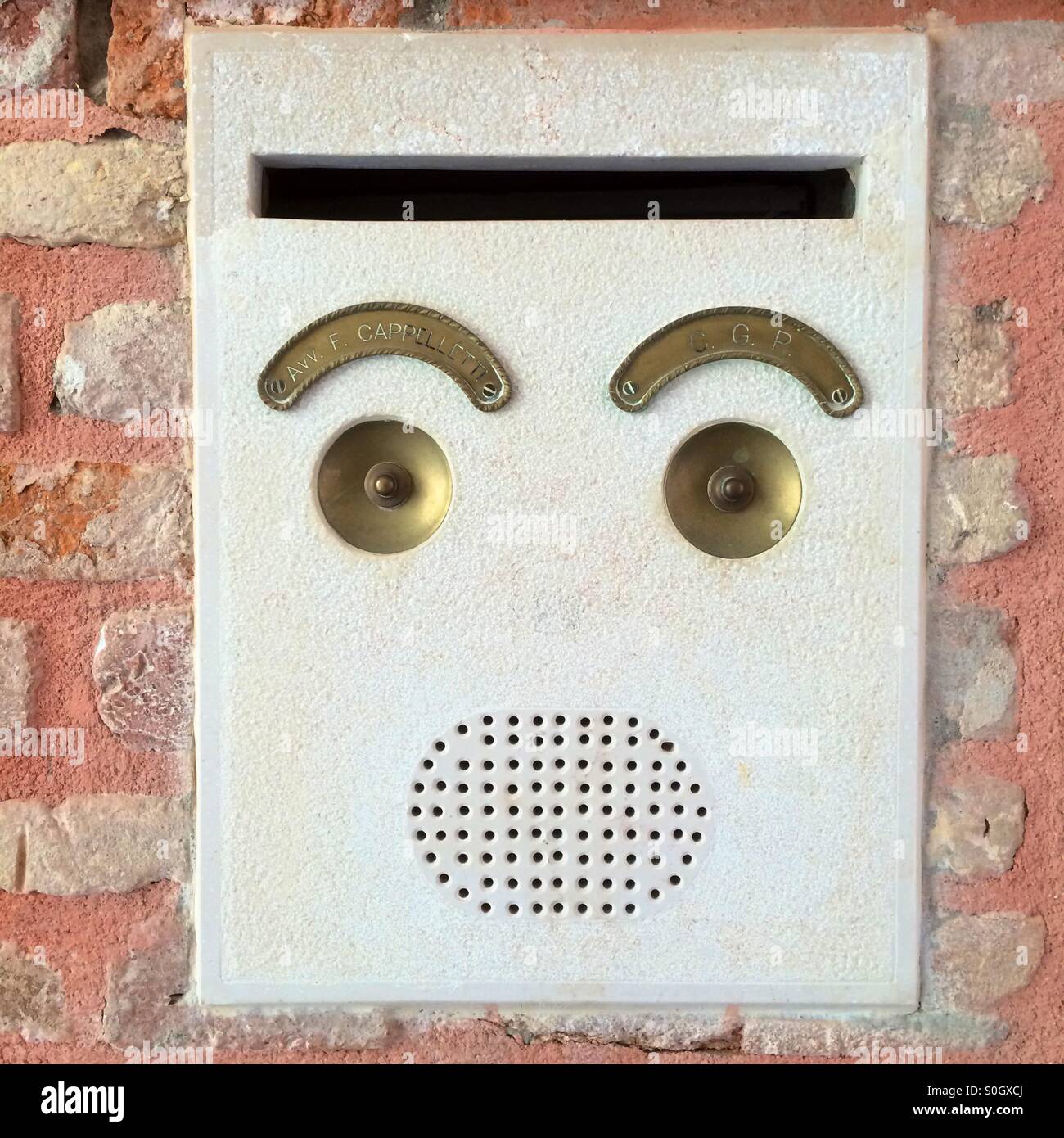 Doorbells in Venice looking like a face with eyebrows. - Smartphone Captured Stock Image