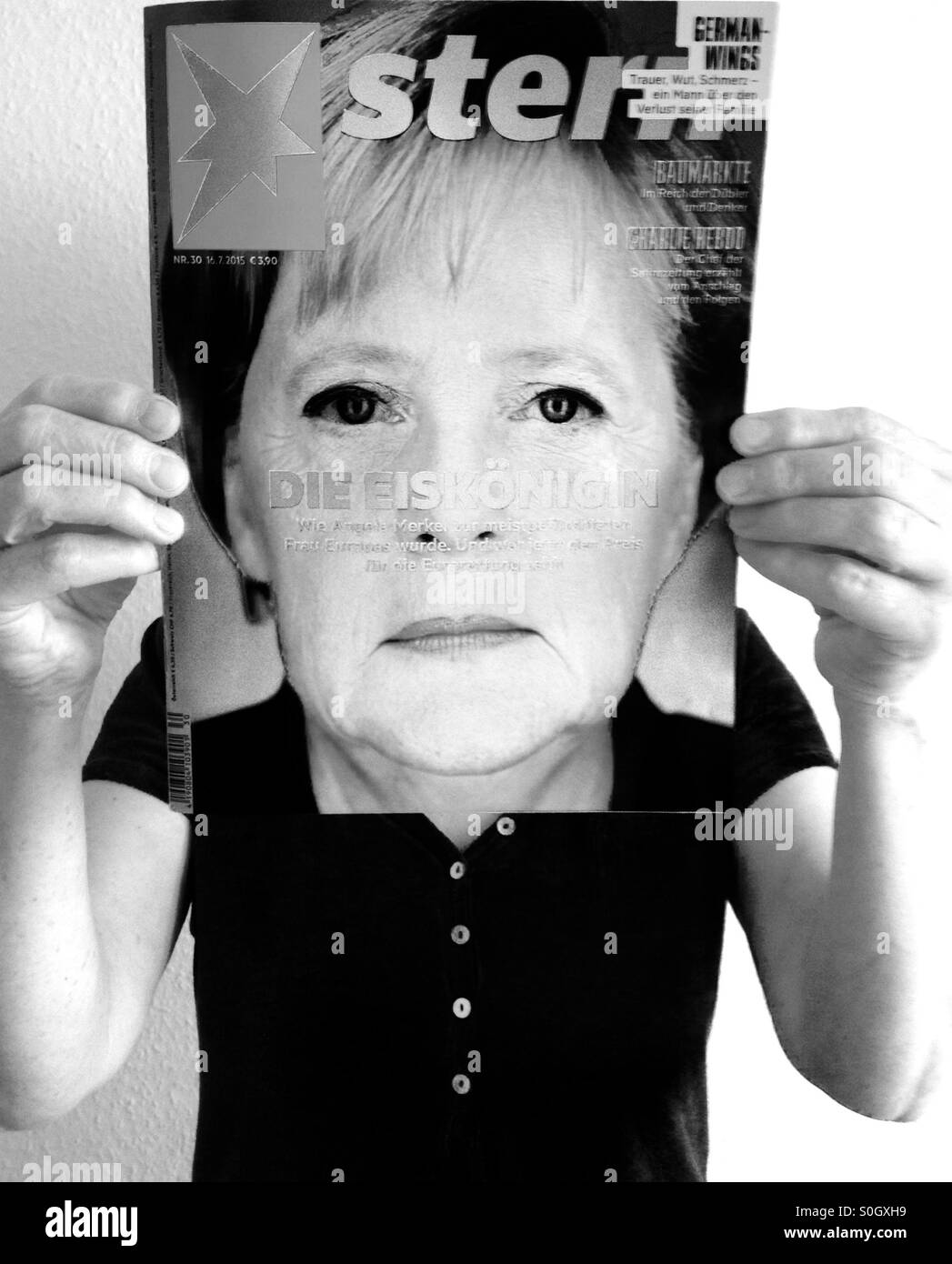 Woman reading a copy of the German weekly news magazine Stern (16.7.2015) - Smartphone Captured Stock Image