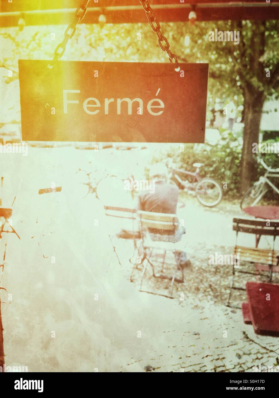 View out of a Cafe in Berlin Kreuzberg with a french Closed sign in the foreground - Smartphone Captured Stock Image