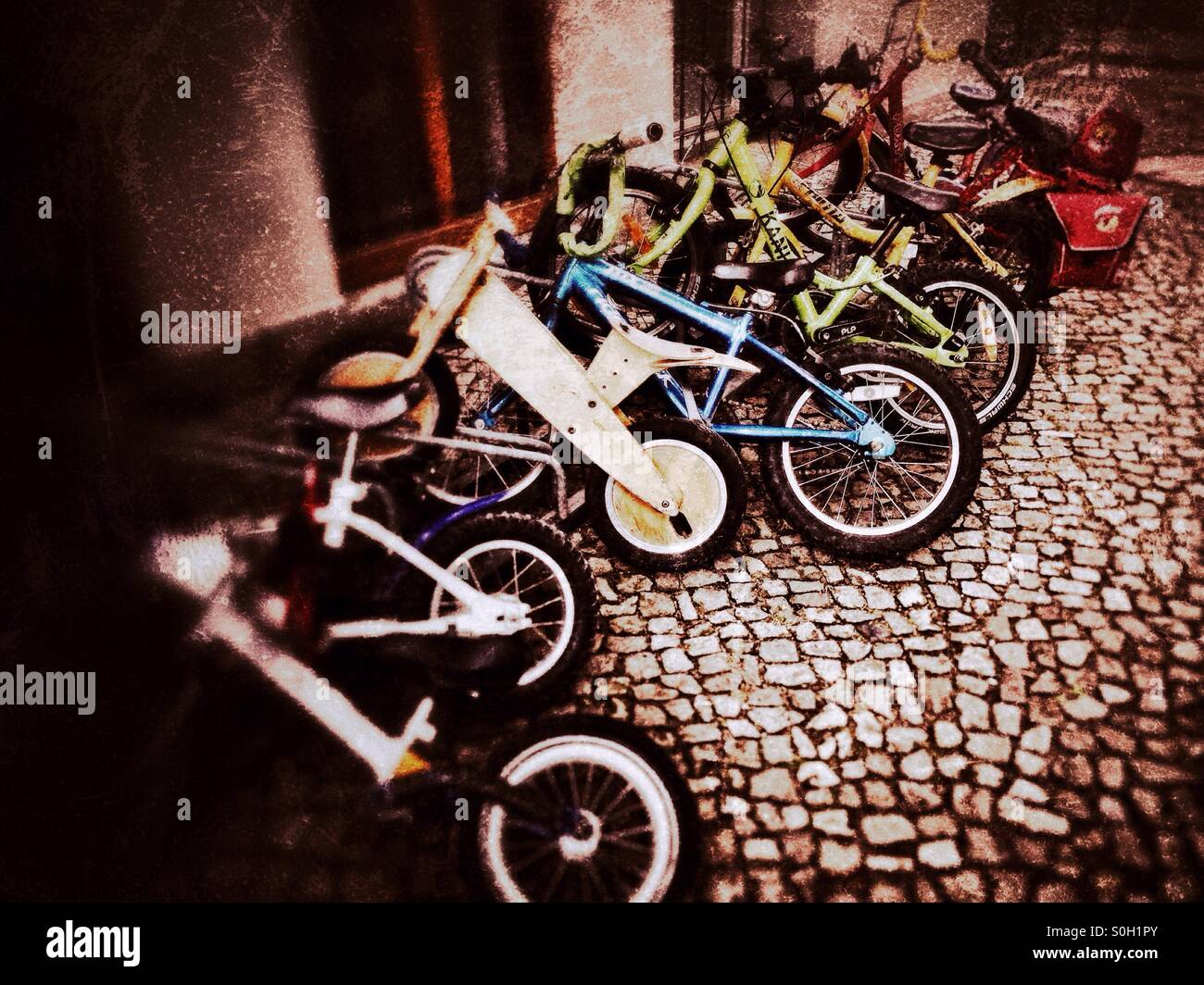 Small Bikes for Children in Front of a Daycare Centre in Berlin Stock Photo