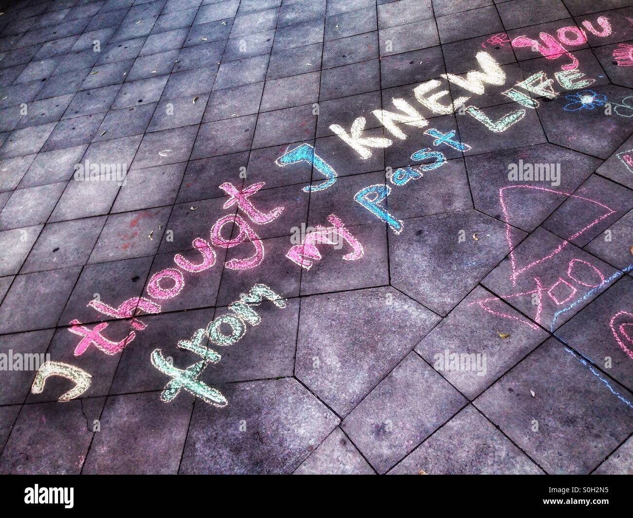 A message about love and connection written in the pavement of the sidewalk with chalk in Neukölln, Berlin, Germany Stock Photo