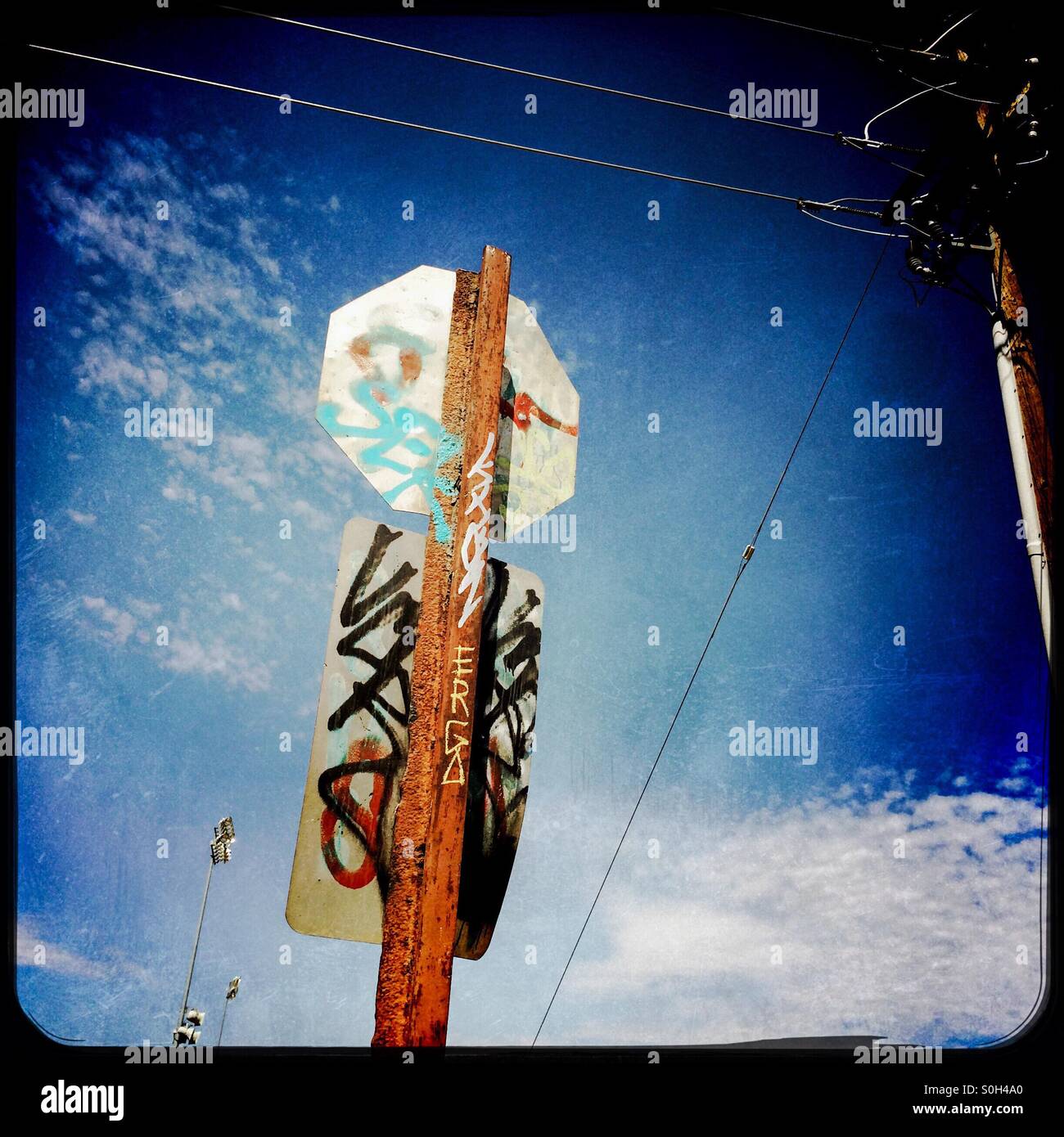 An old stop sign covered in graffiti. - Smartphone Captured Stock Image