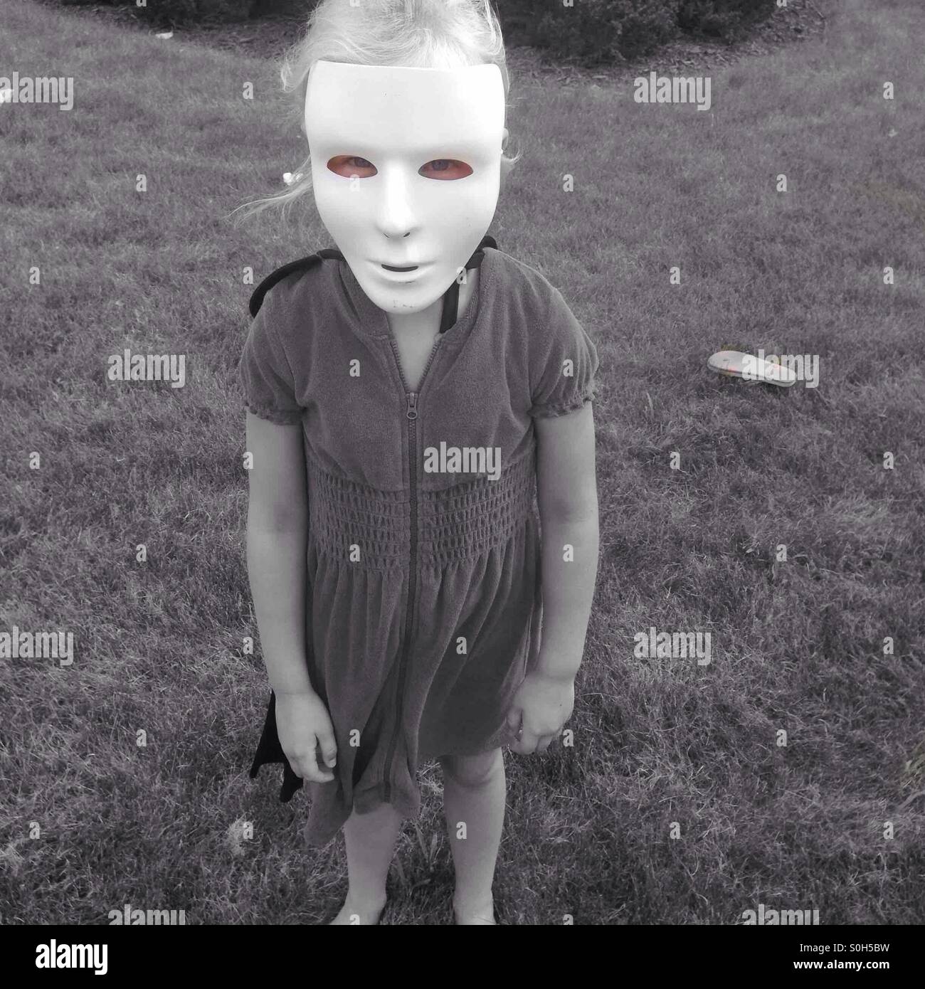 Girl wearing Halloween mask Stock Photo Alamy