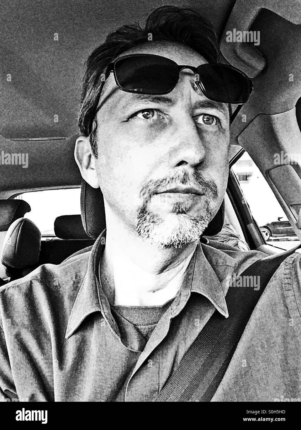 Selfie of a man in his car, wearing his sunglasses on his front - Smartphone Captured Stock Image