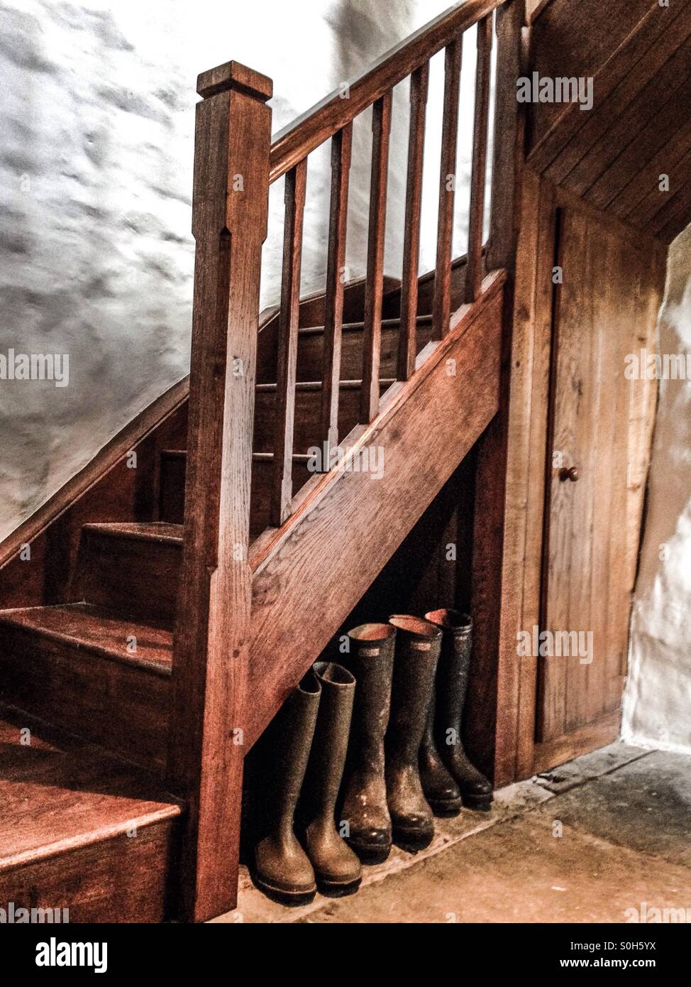 Our wellingtons sitting snugly at the farmhouse in Wales. Stock Photo
