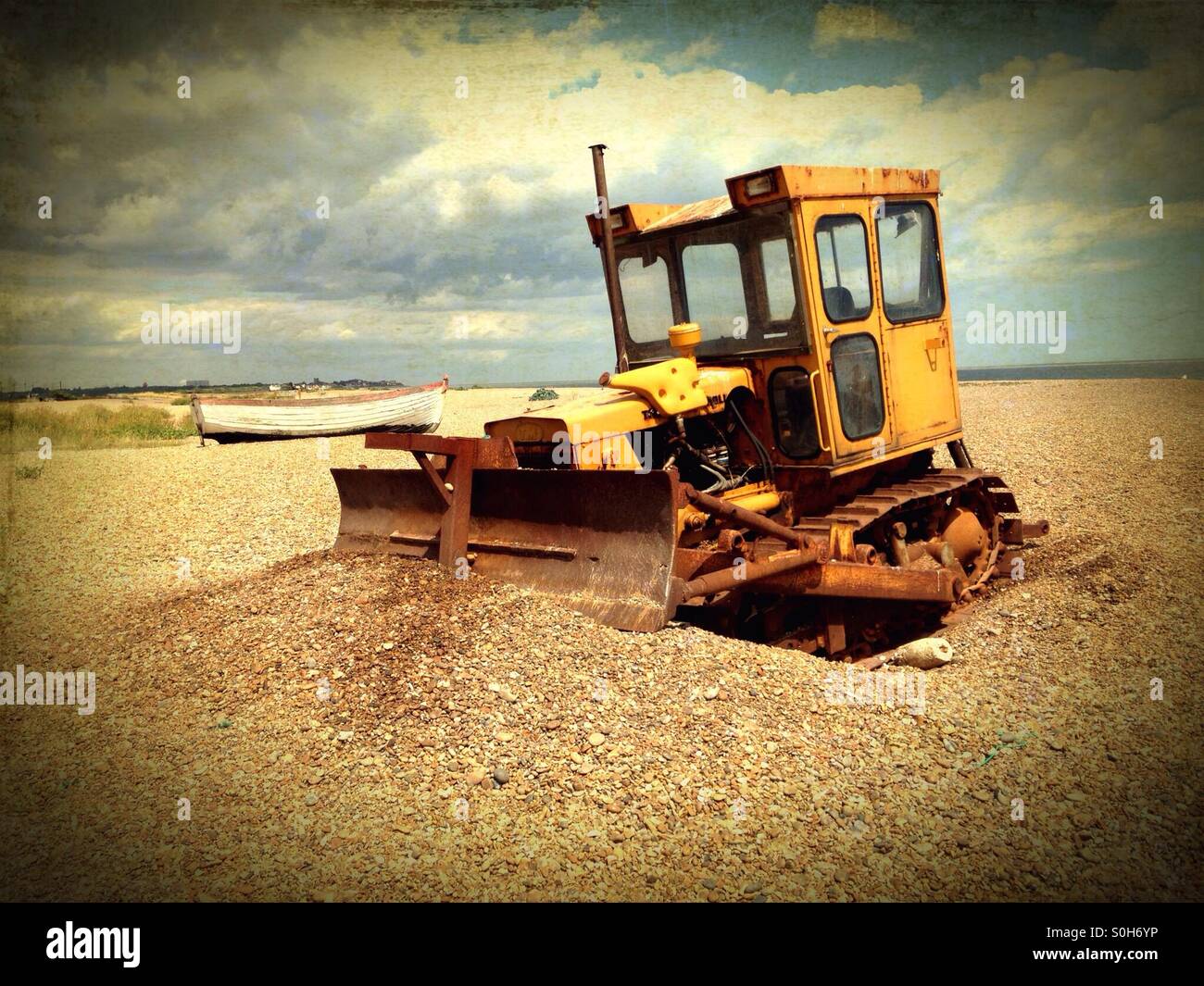 Caterpillar bulldozer on the shingle beach at Aldeburgh, Suffolk, England. - Smartphone Captured Stock Image