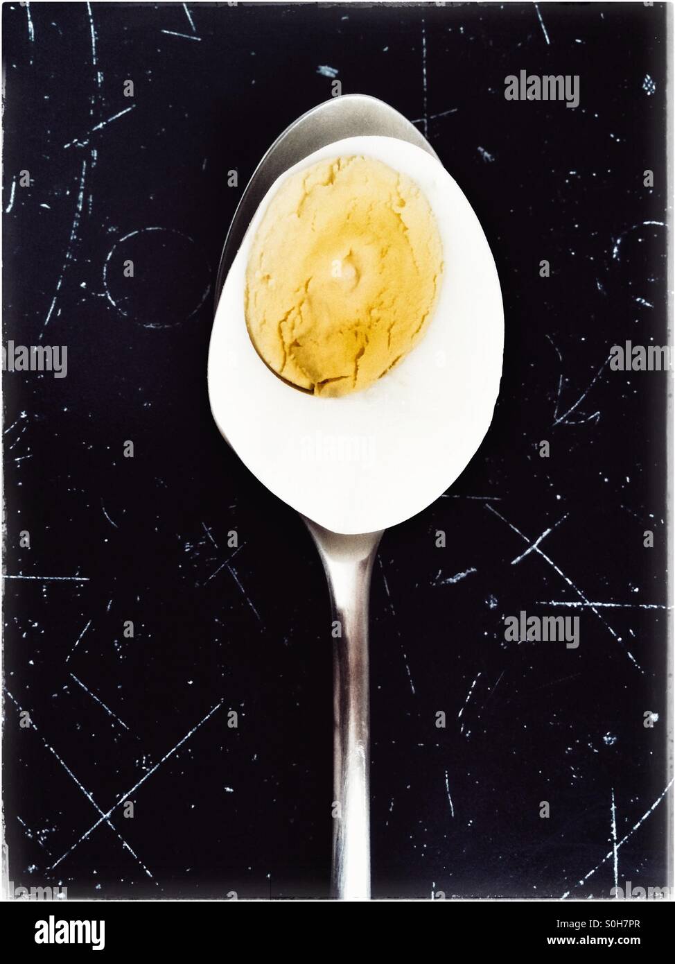 Hard boiled egg on spoon. - Smartphone Captured Stock Image