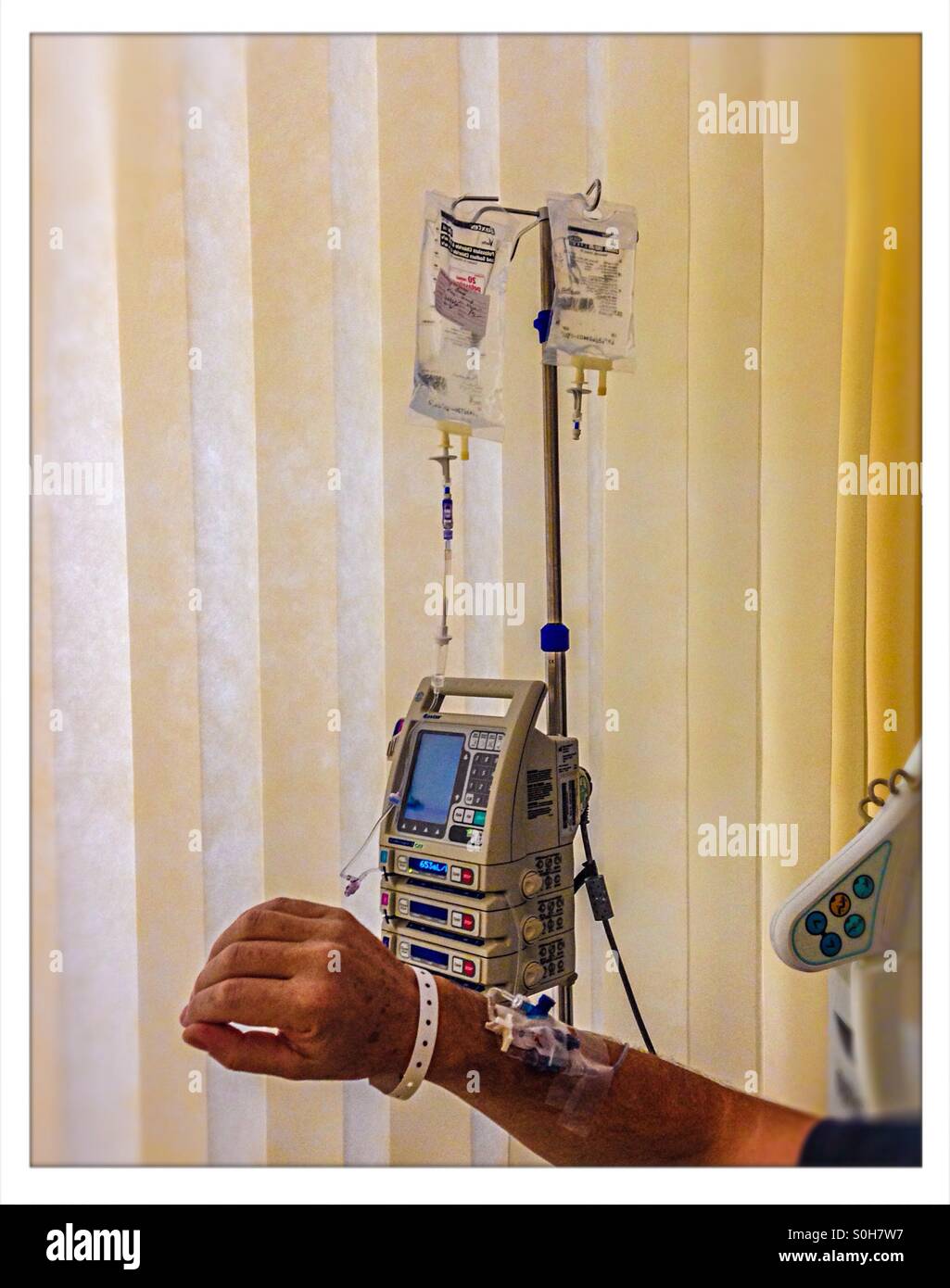 Medical attention being given via a drip in hospital Stock Photo