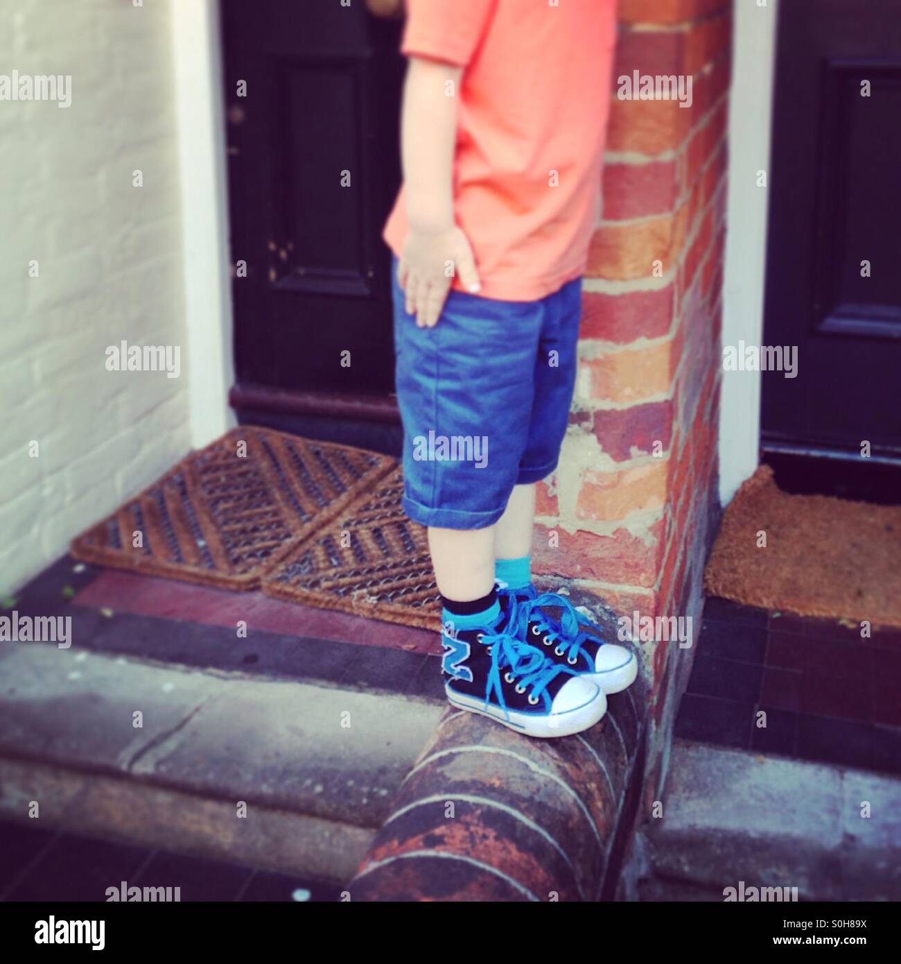 Boy standing on a wall - Smartphone Captured Stock Image