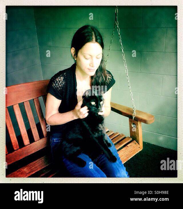 Woman petting black cat - Smartphone Captured Stock Image