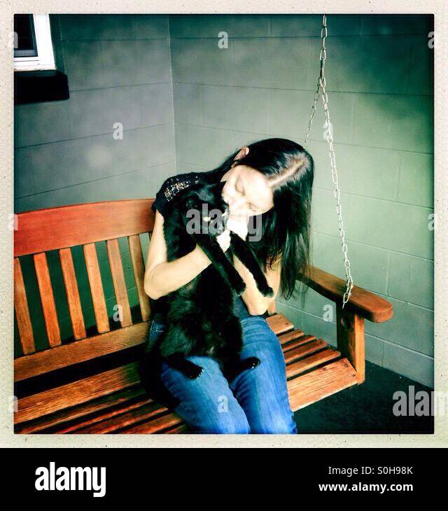 Woman hugging black cat - Smartphone Captured Stock Image