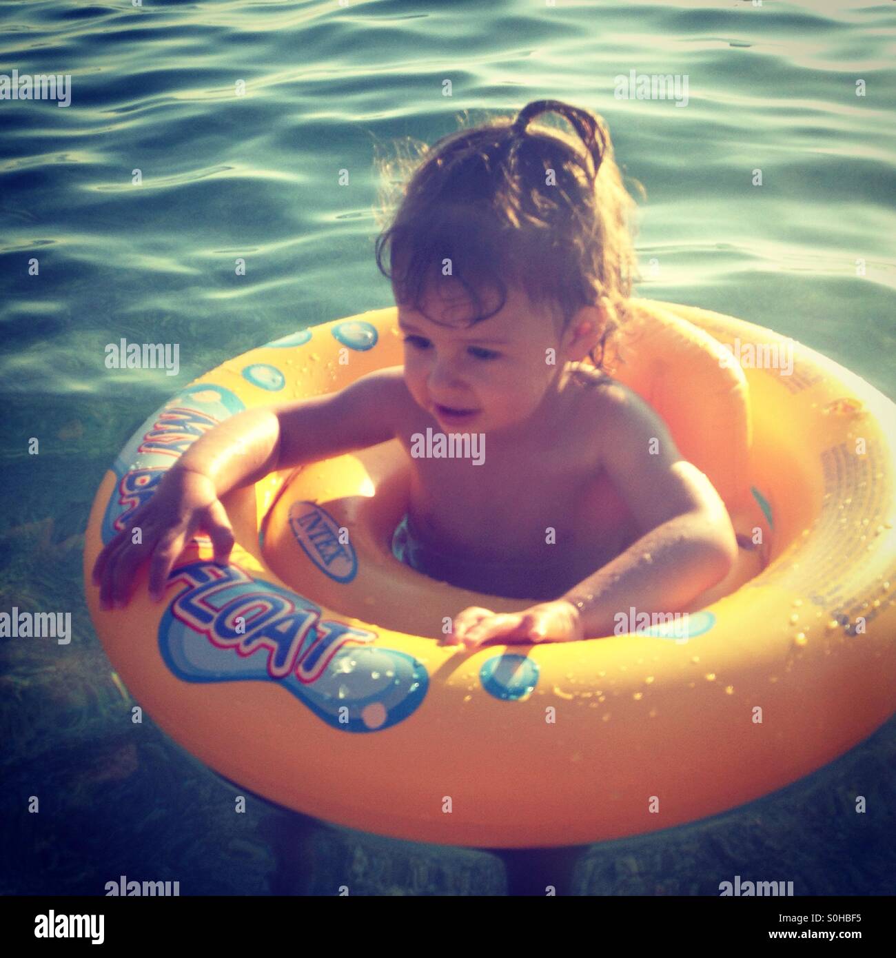 Baby girl bathing in sea Stock Photo