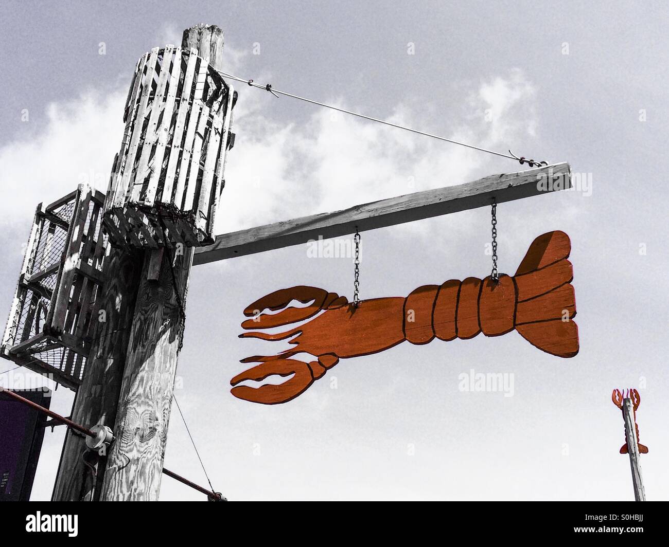 A lobster sign hangs over a fish restaurant - Smartphone Captured Stock Image
