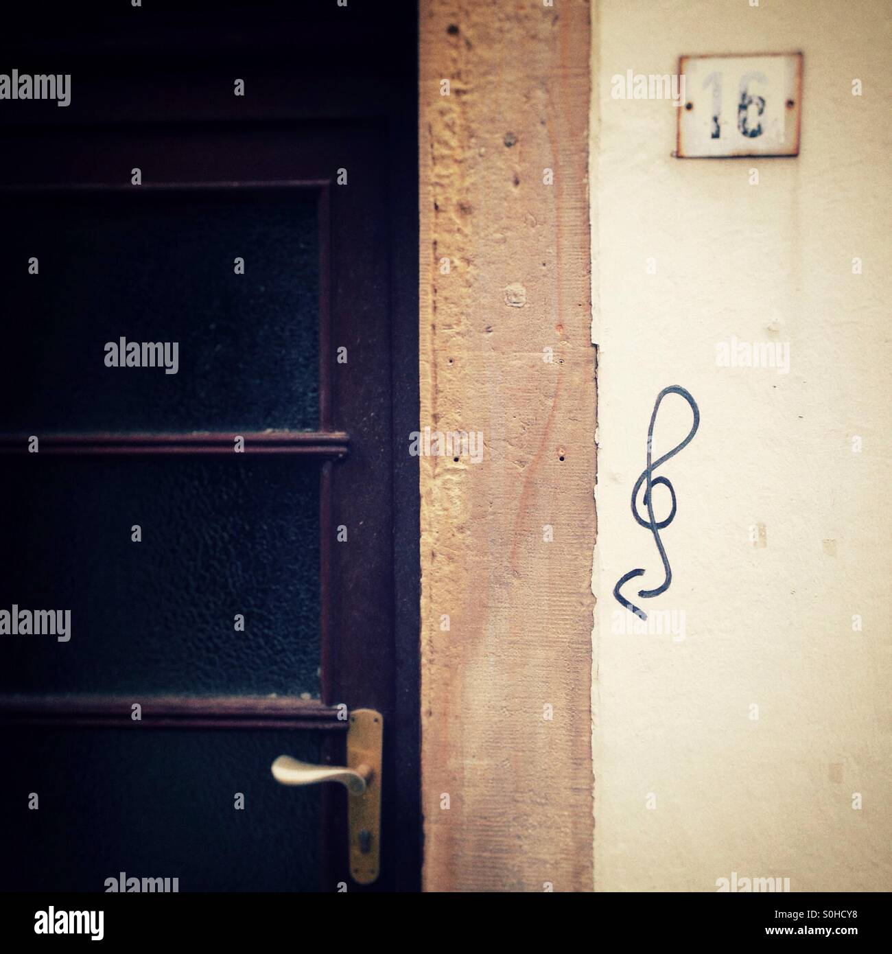 Door in the schnoor in Bremen Germany with a clef Graffiti Painted in the Wall next to it - Smartphone Captured Stock Image