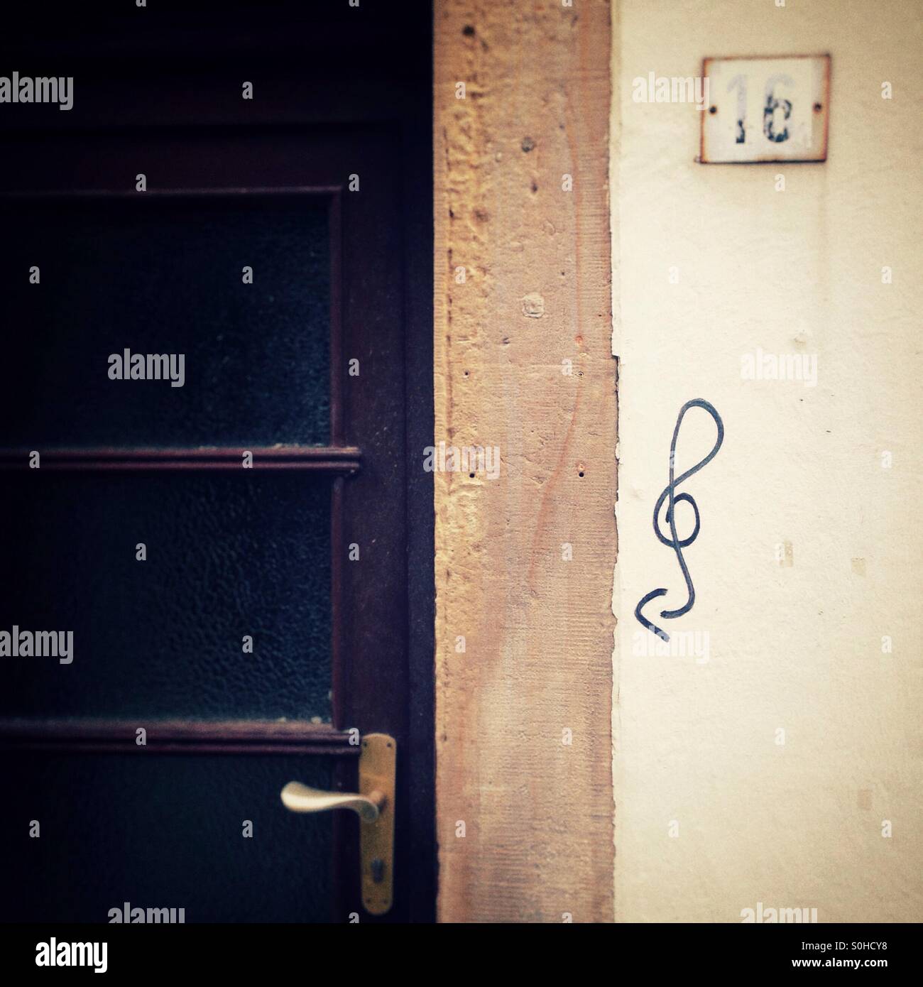 Door in the schnoor in Bremen Germany with a clef Graffiti Painted in the Wall next to it Stock Photo