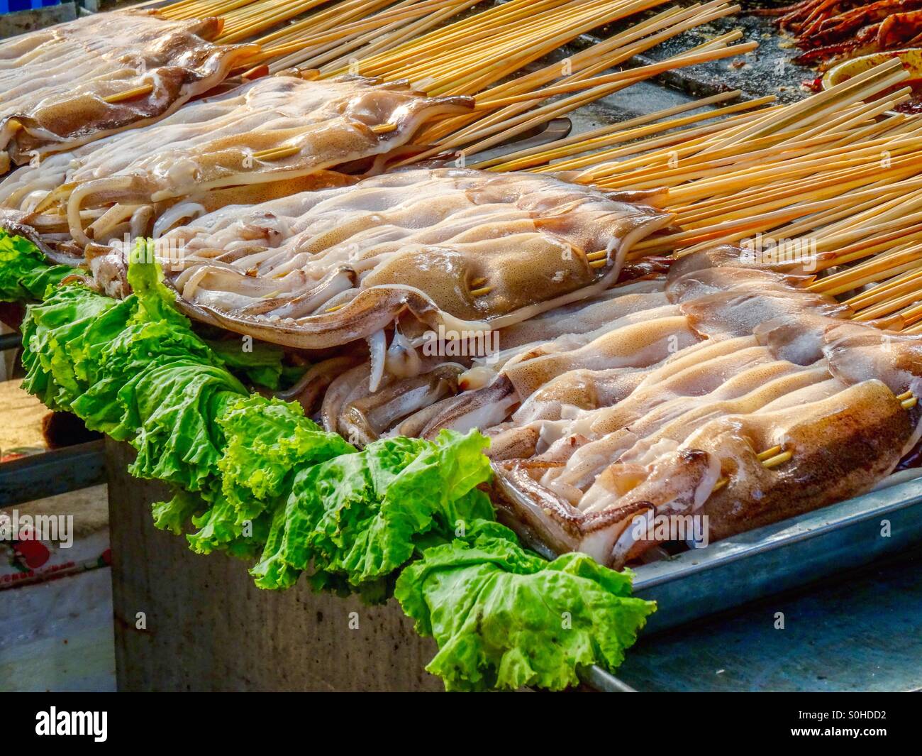 Mini squid for sale for consumption Stock Photo - Alamy