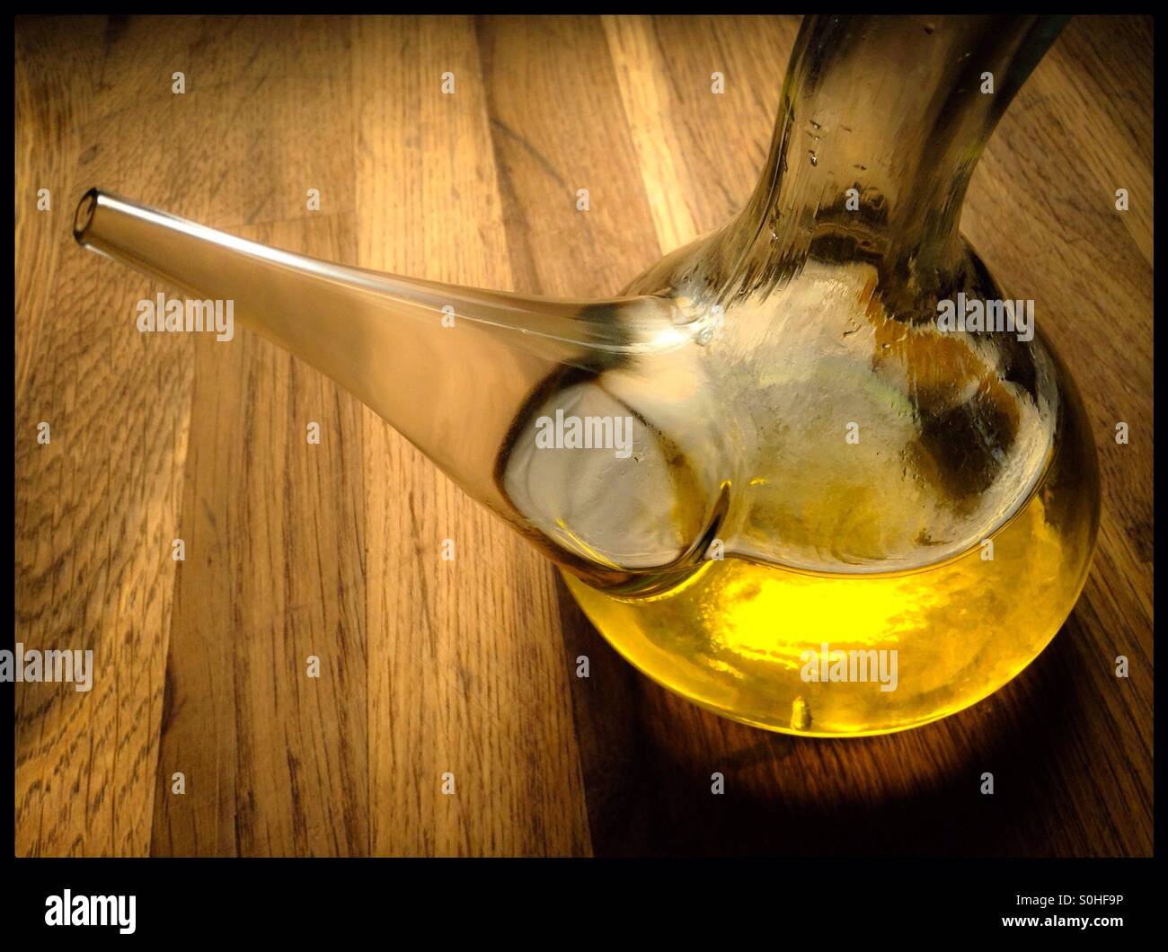 Extra virgin olive oil in a cruet glass dispenser. - Smartphone Captured Stock Image