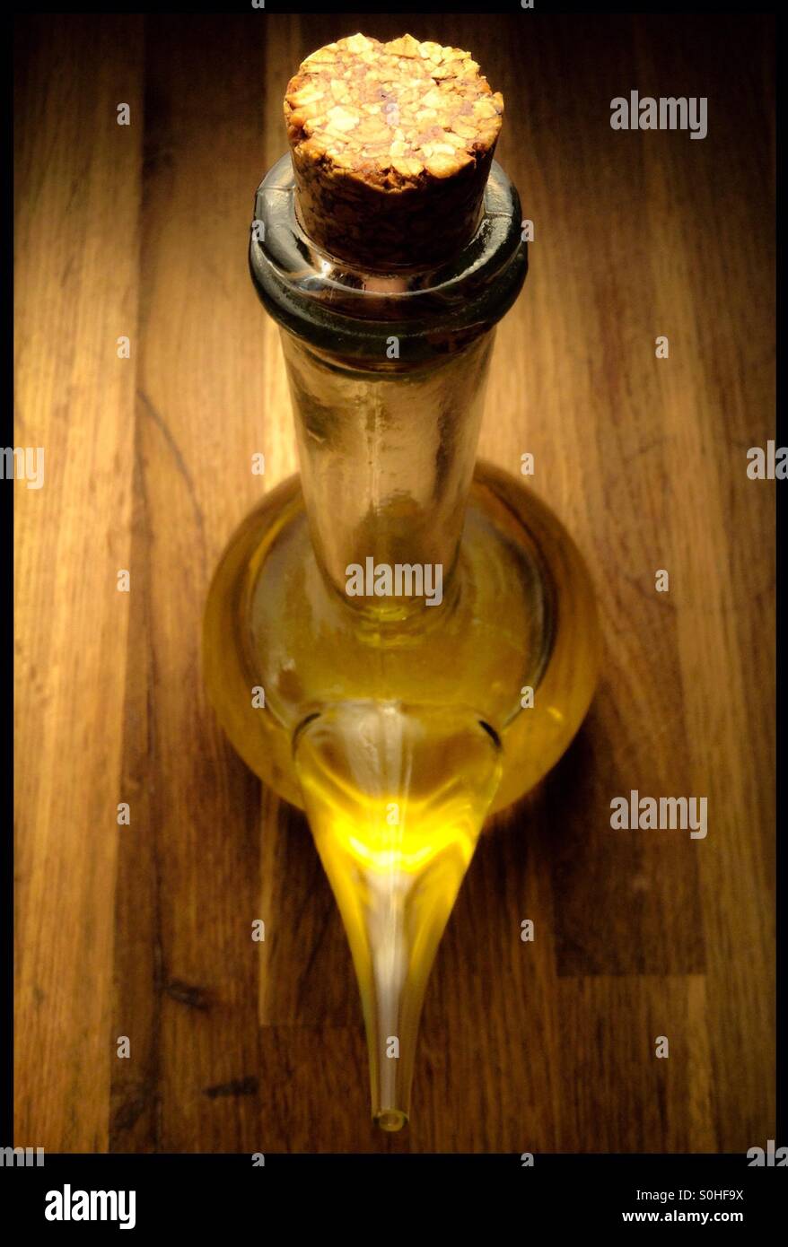 Extra virgin olive oil in a cruet glass dispenser. - Smartphone Captured Stock Image