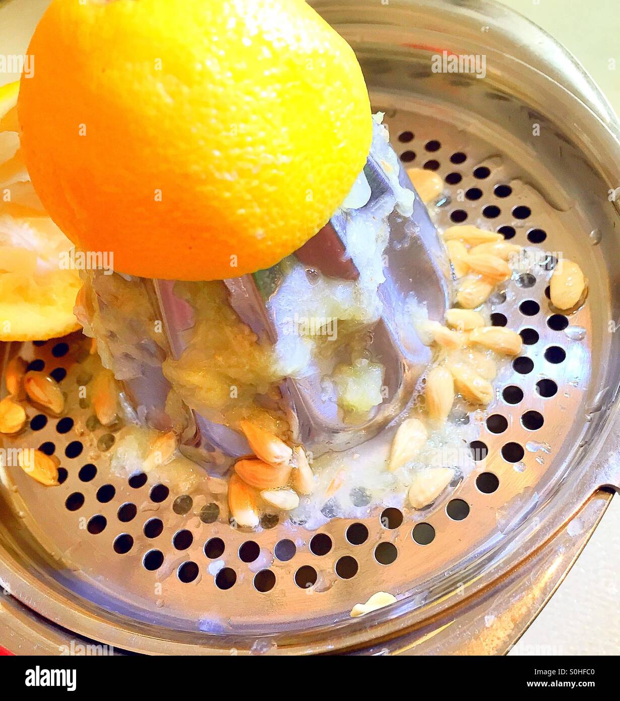 Lemon juice and seeds on a hand juicer. - Smartphone Captured Stock Image