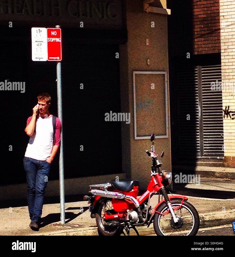Red colours, colour red, man talking on an old mobile phone - Smartphone Captured Stock Image
