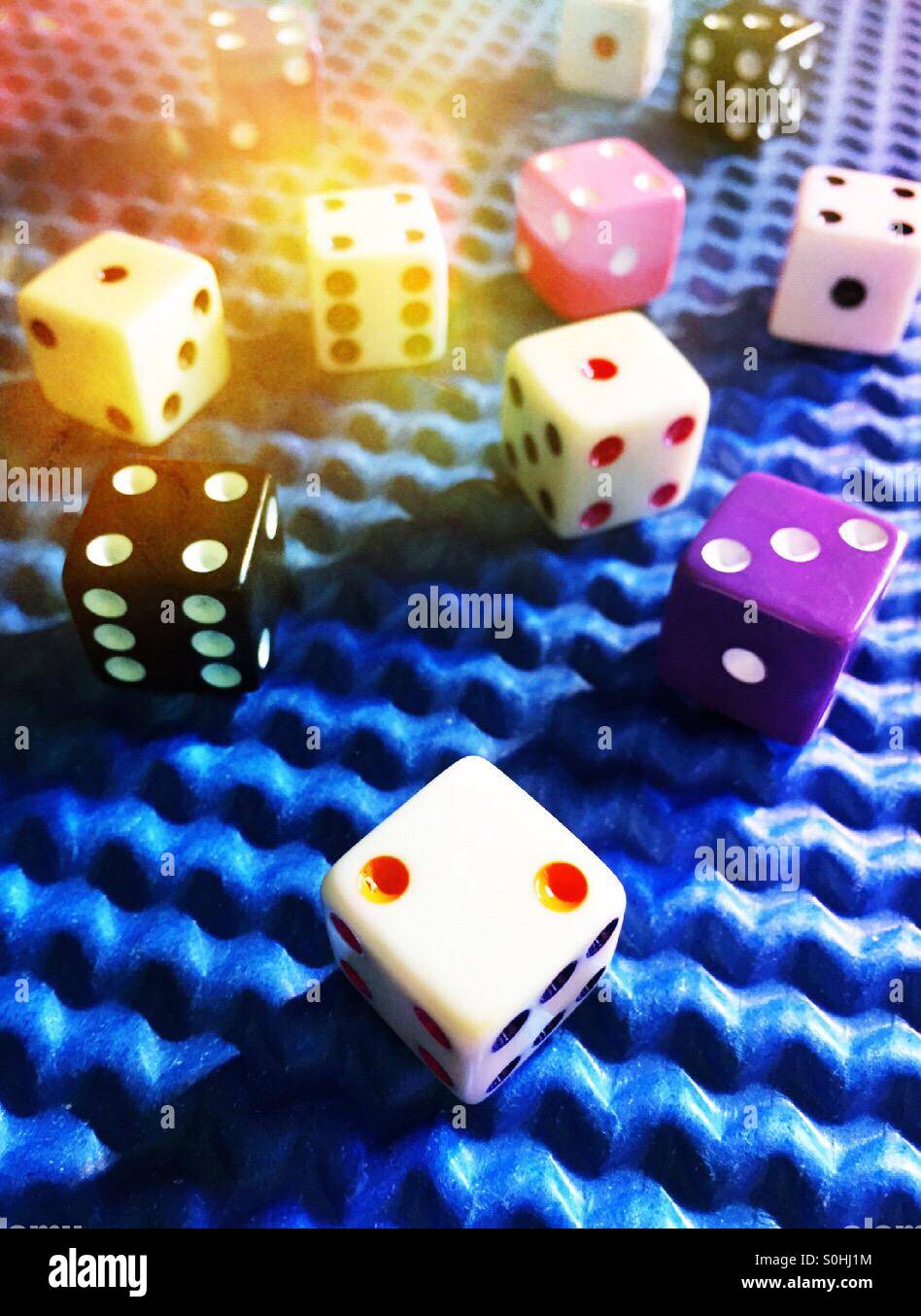 Colorful dice on textured blue background - Smartphone Captured Stock Image