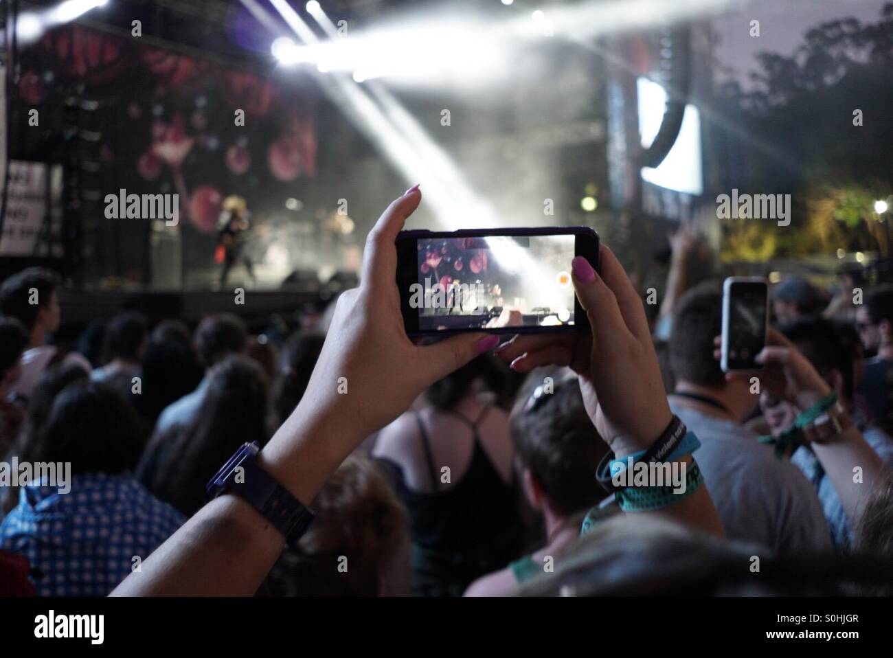 A smartphone being used to video at a music festival Stock Photo