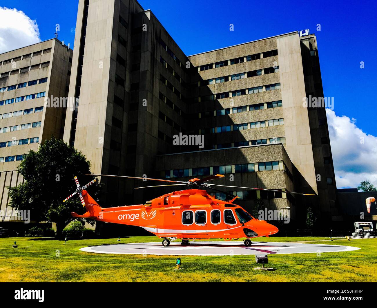 Air ambulance. An ambulance helicopter on a landing pad outside a teaching hospital, Ontario, Canada. Between flights. No people. - Smartphone Captured Stock Image