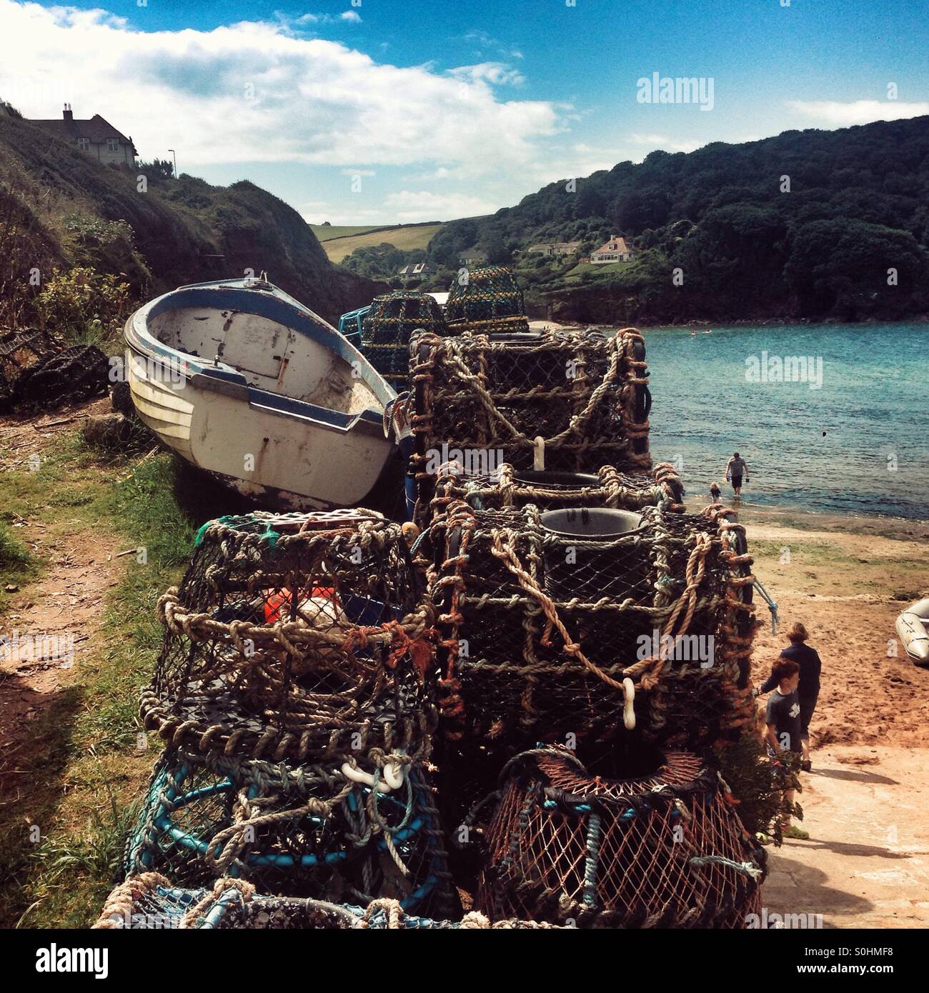 Lobster pots and rowing boat, Hope Cove, Devon, England, United Kingdom. - Smartphone Captured Stock Image