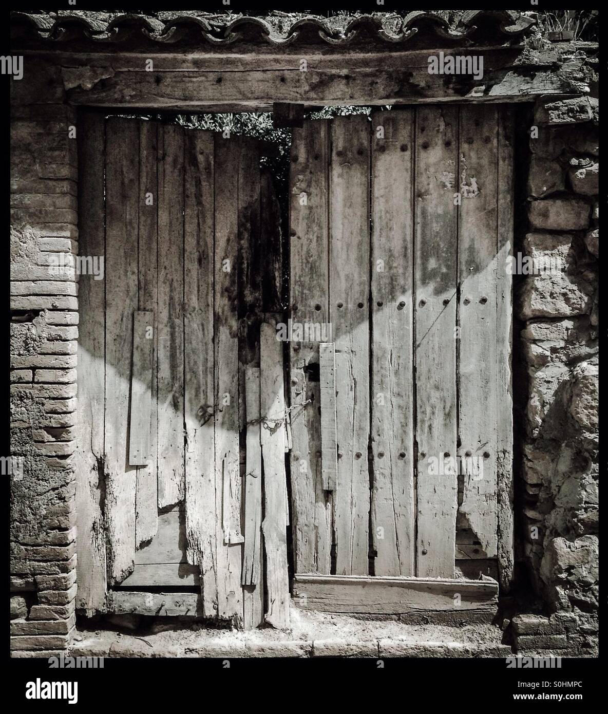 Old ramshackle wooden door in Gandesa, Catalunya, Spain. - Smartphone Captured Stock Image