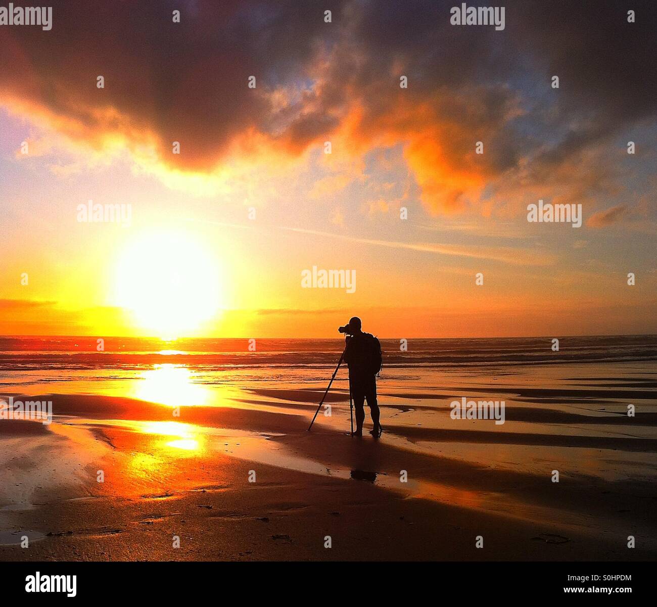 Photographer taking photos at sunset Stock Photo