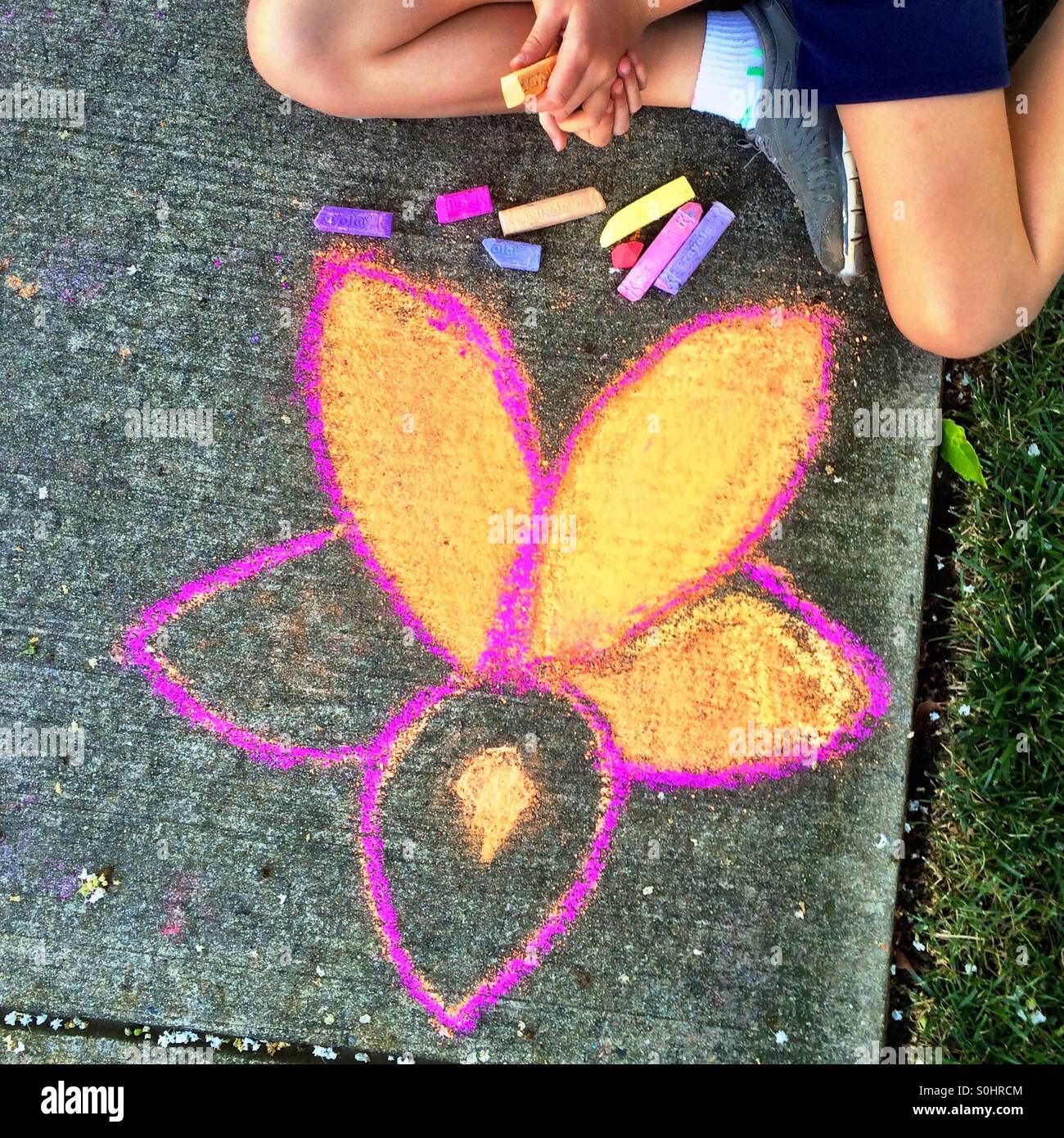 Girl drawing on sidewalk - Smartphone Captured Stock Image