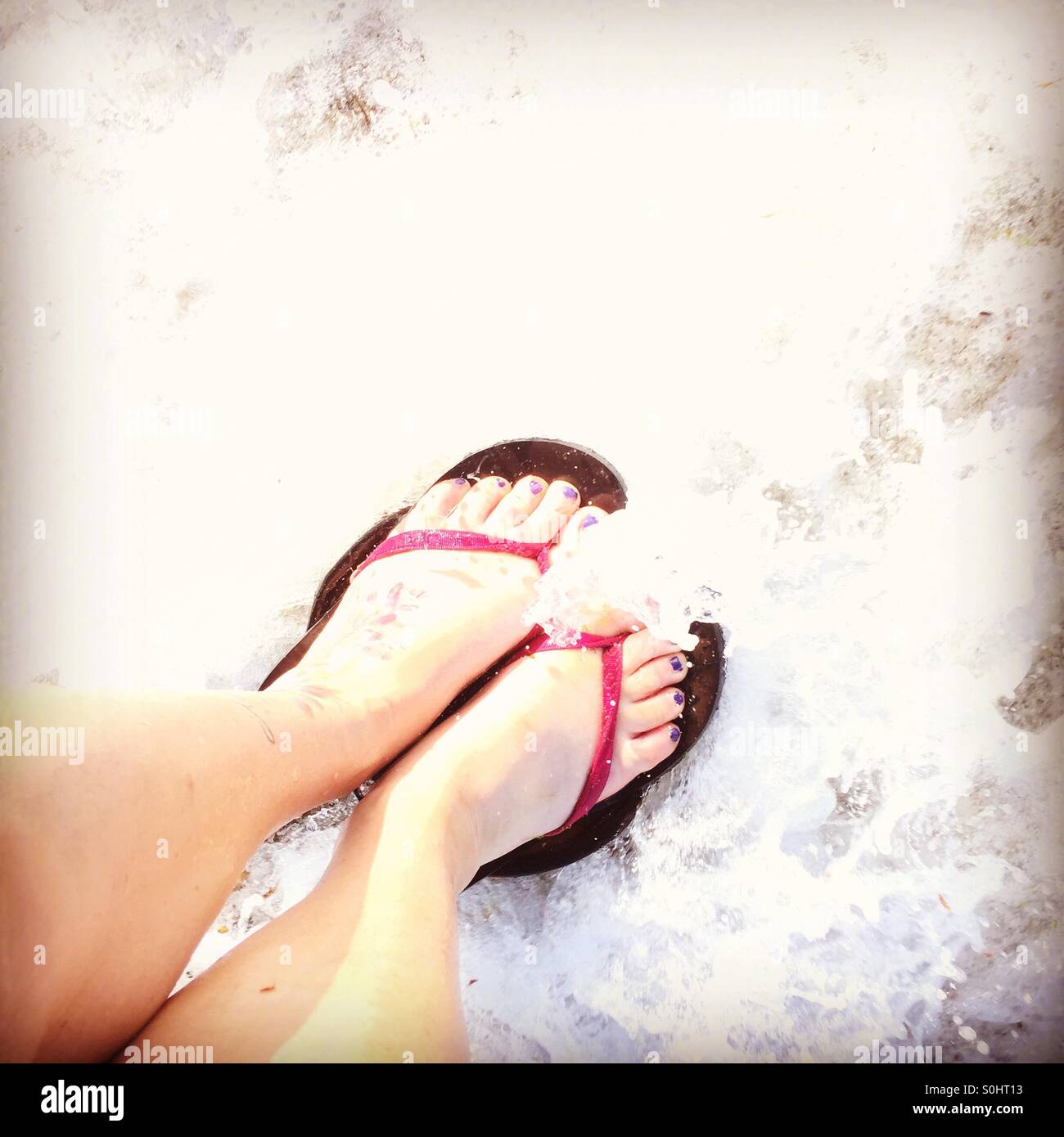 Paddling feet washed out by a wave - Smartphone Captured Stock Image