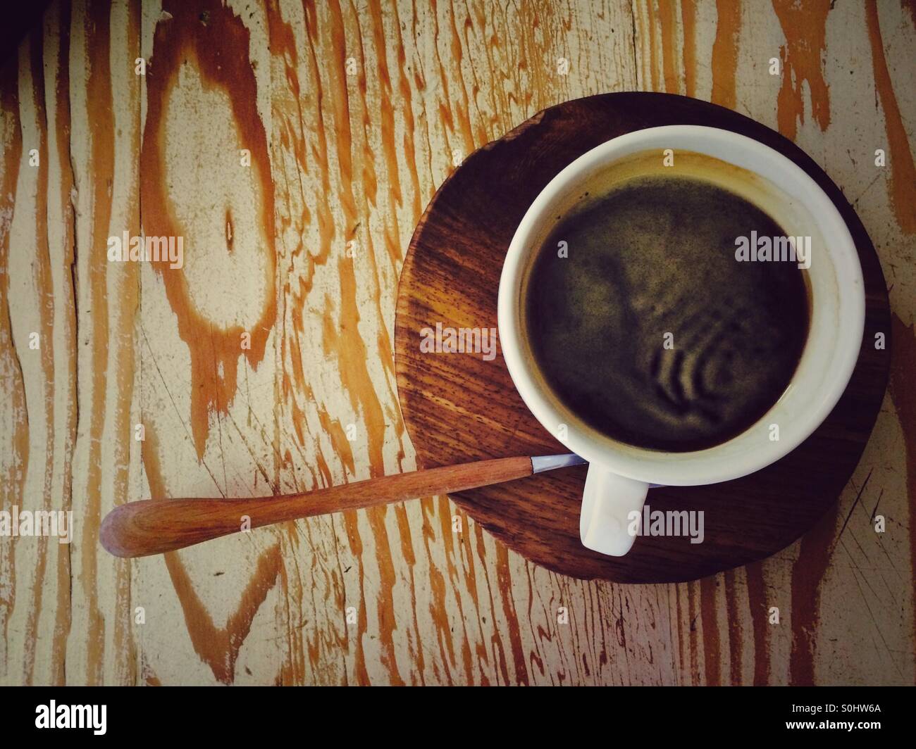 Cup of black coffee on wooden table. - Smartphone Captured Stock Image
