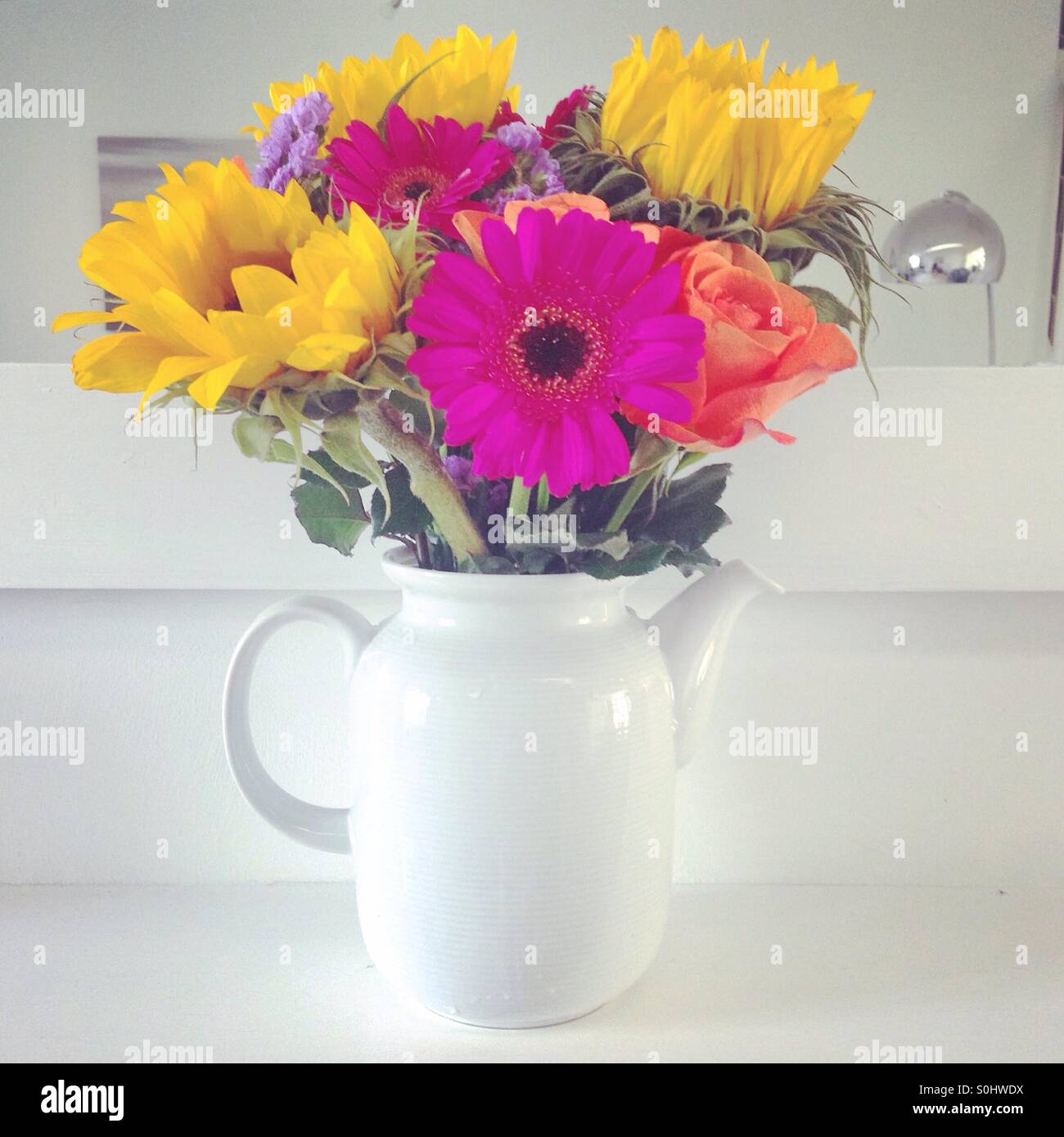 Flowers in teapot vase Stock Photo Alamy