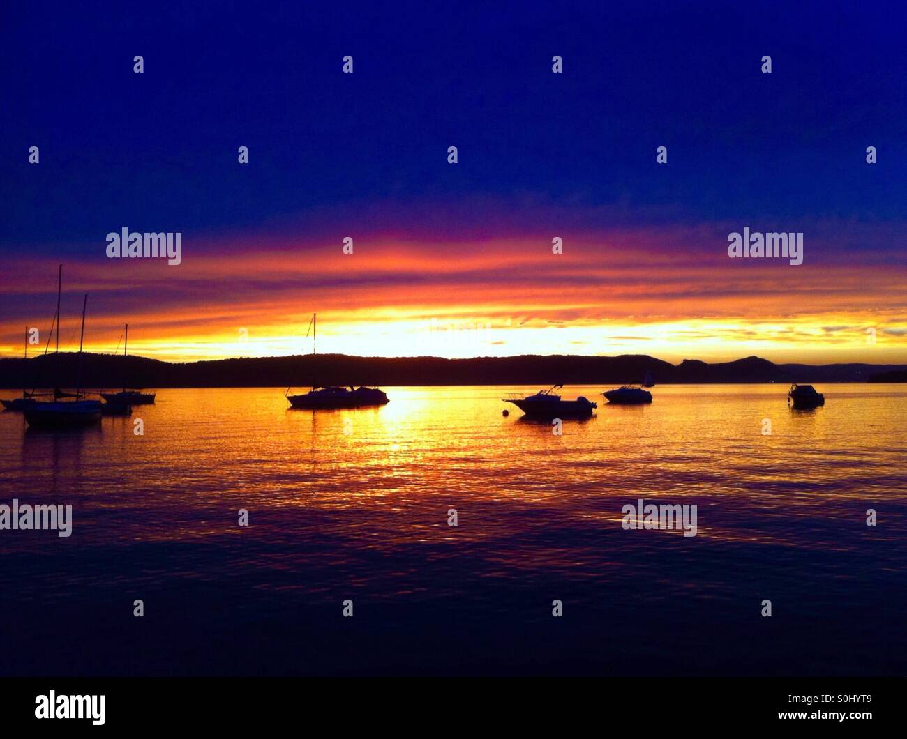 Fishing boats docked at harbor side Stock Photo Alamy