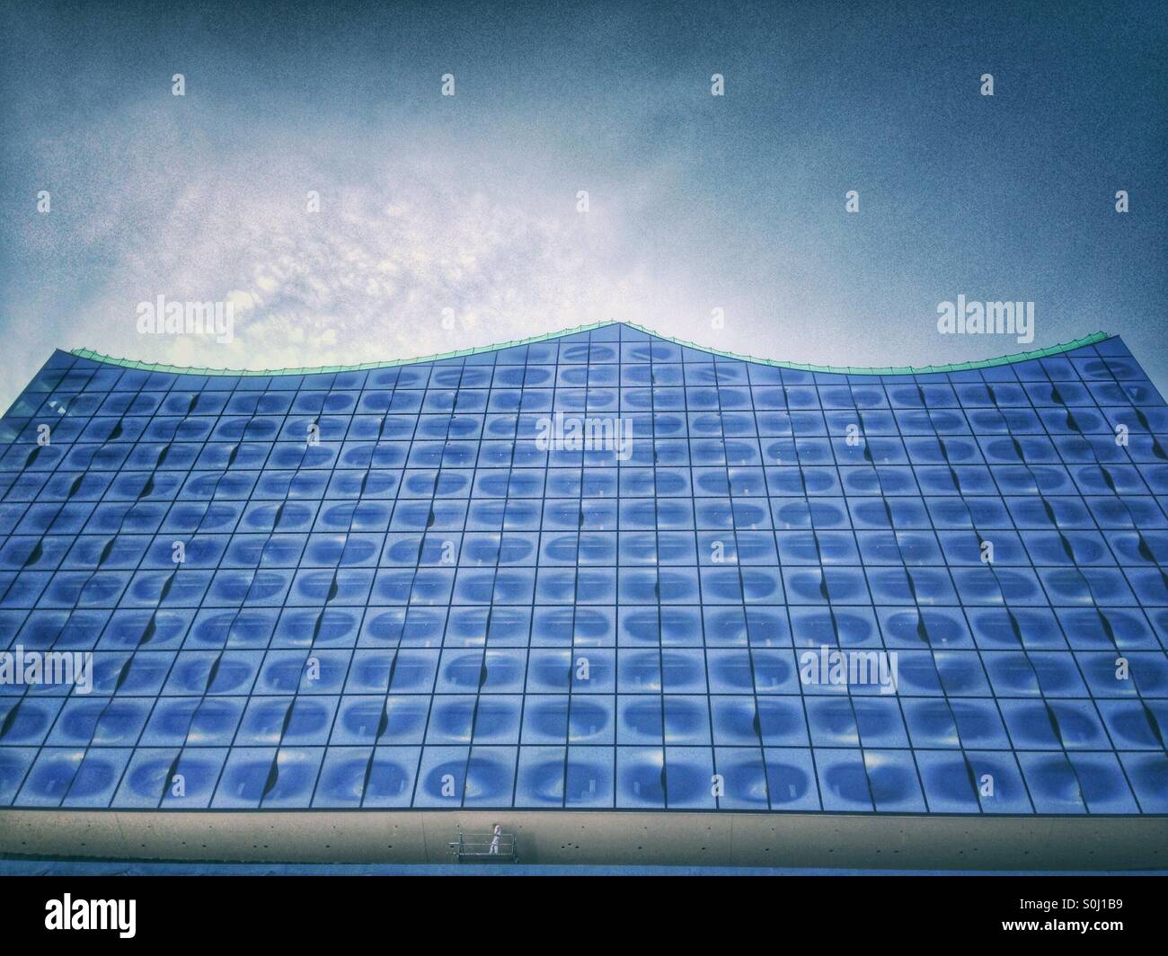 Elbphilharmonie, Elbe Philharmonic Hall, backside, a sinke painter working on a platform painting a ceiling showing the scale of the building, Hamburg, Germany, August 2015 - Smartphone Captured Stock Image