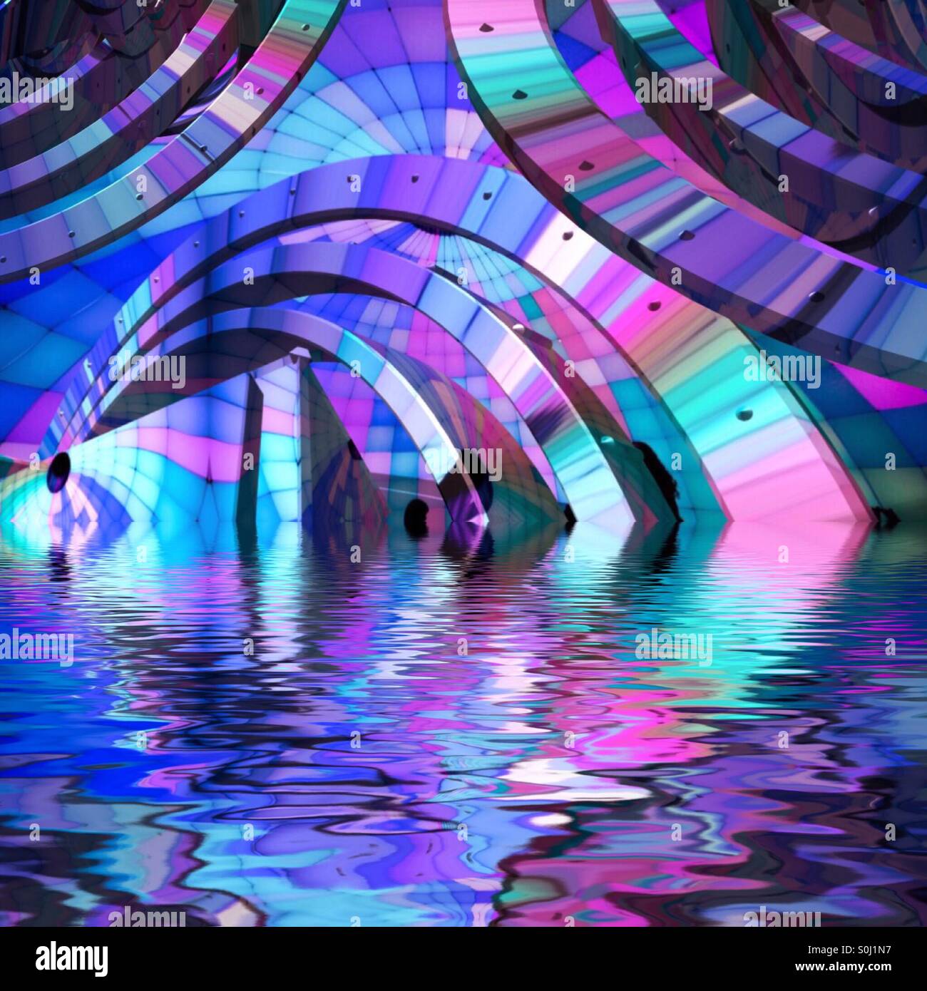 An abstract image of blue, pink, purple and Aqua curved shapes reflecting in water. Stock Photo
