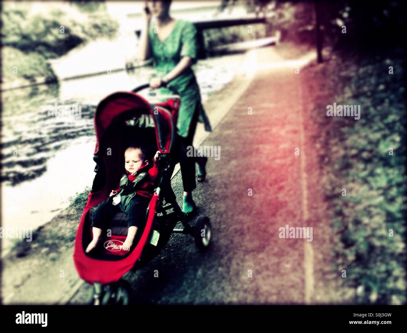 Baby in buggy along the Grand Union Canal, Greenford, London Borough of