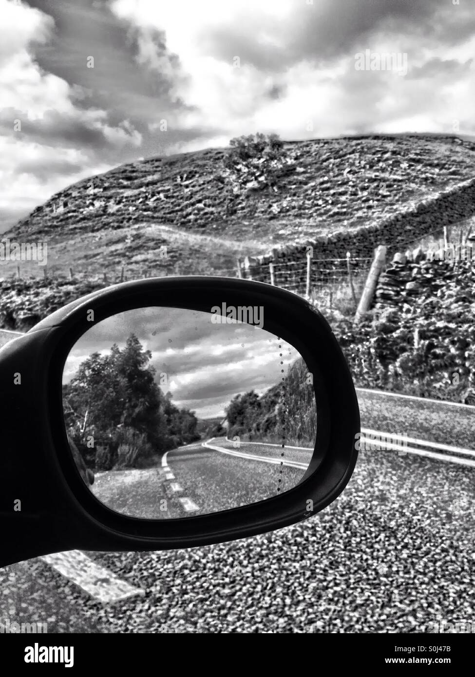 Wing mirror on a car with road - Smartphone Captured Stock Image