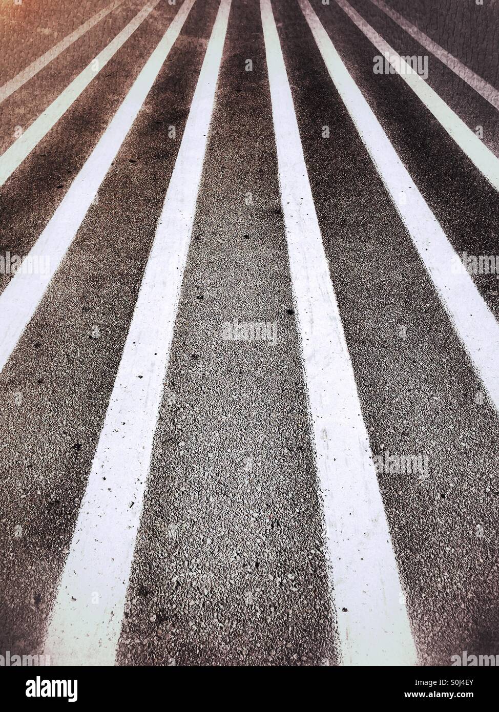 Stripes vertical to the horizon on a paved asphalt road Stock Photo