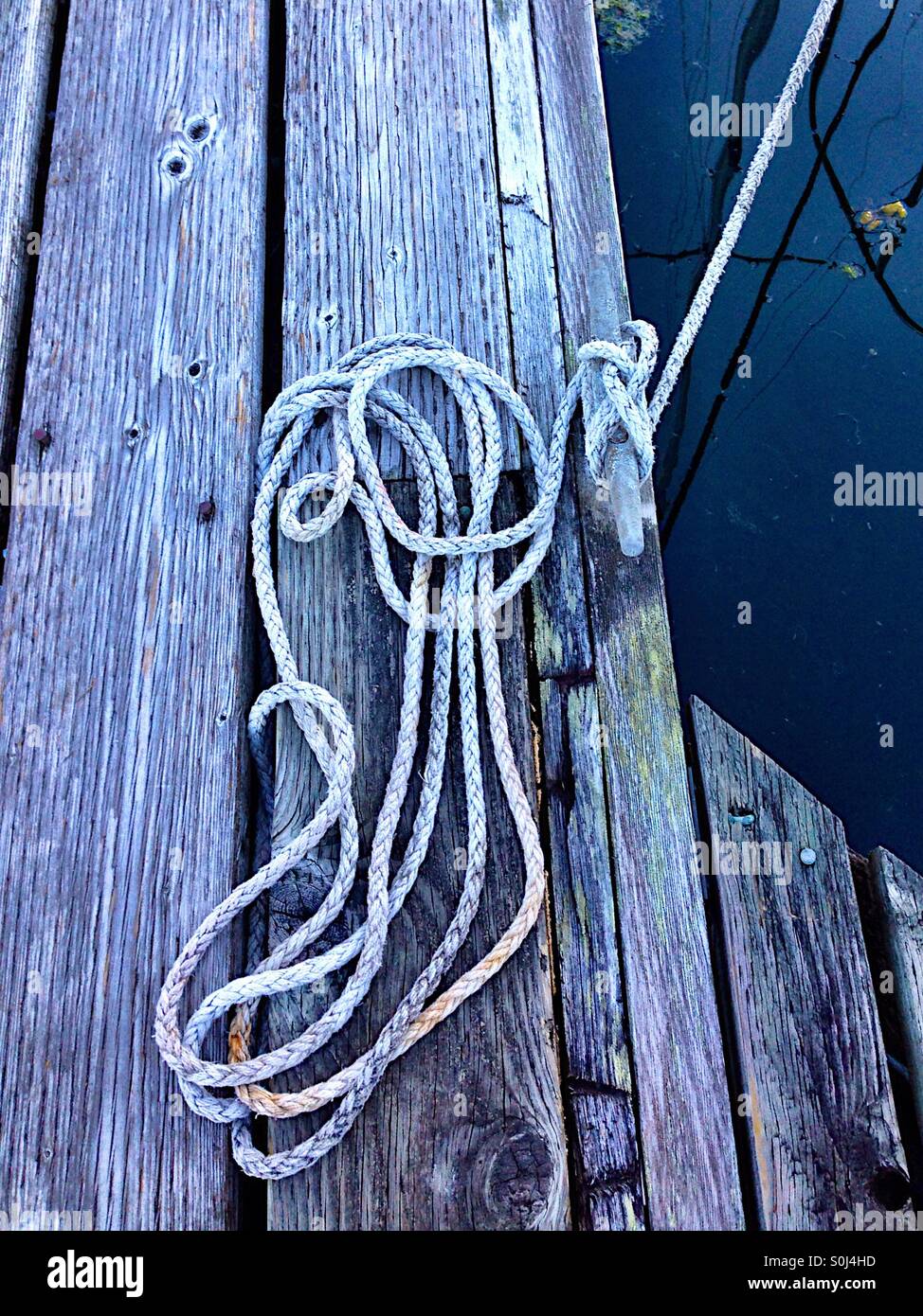 Rope lashed on a wooden deck - Smartphone Captured Stock Image
