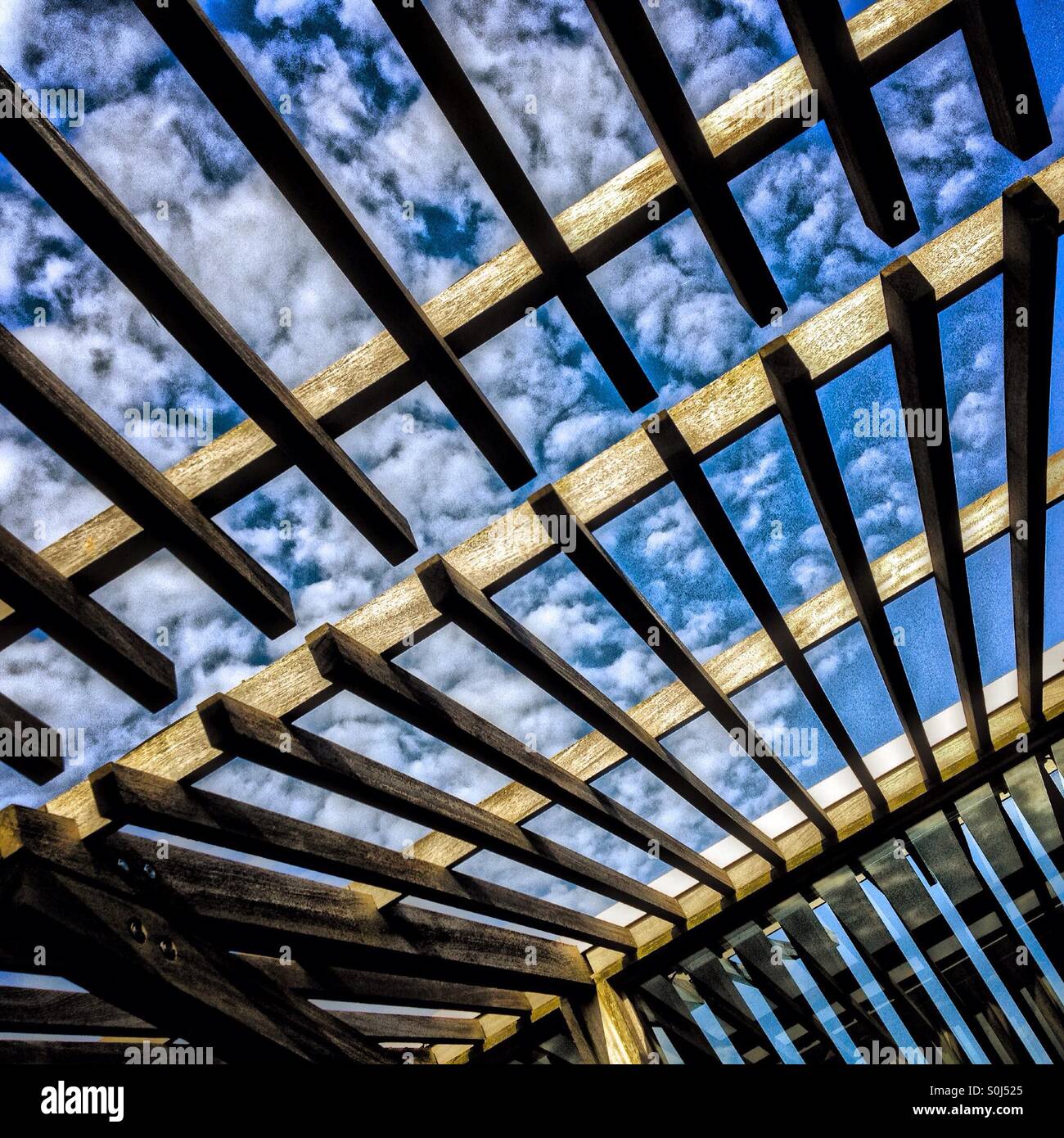 Wooden lattice against a white cloudy sky - Smartphone Captured Stock Image