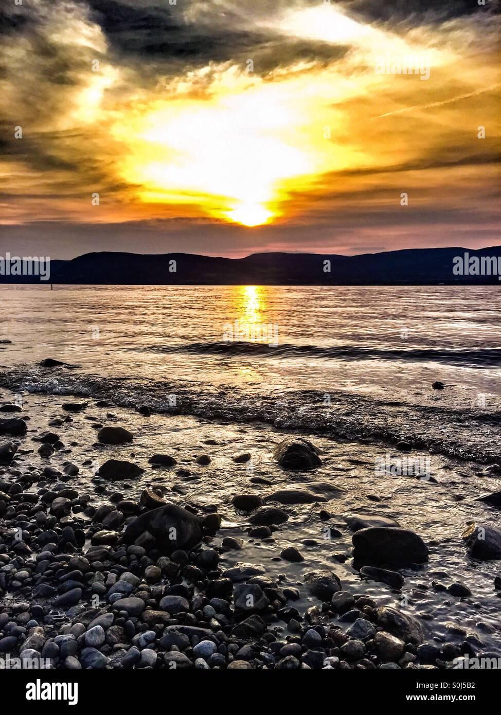 Rocky beach at sunset. - Smartphone Captured Stock Image
