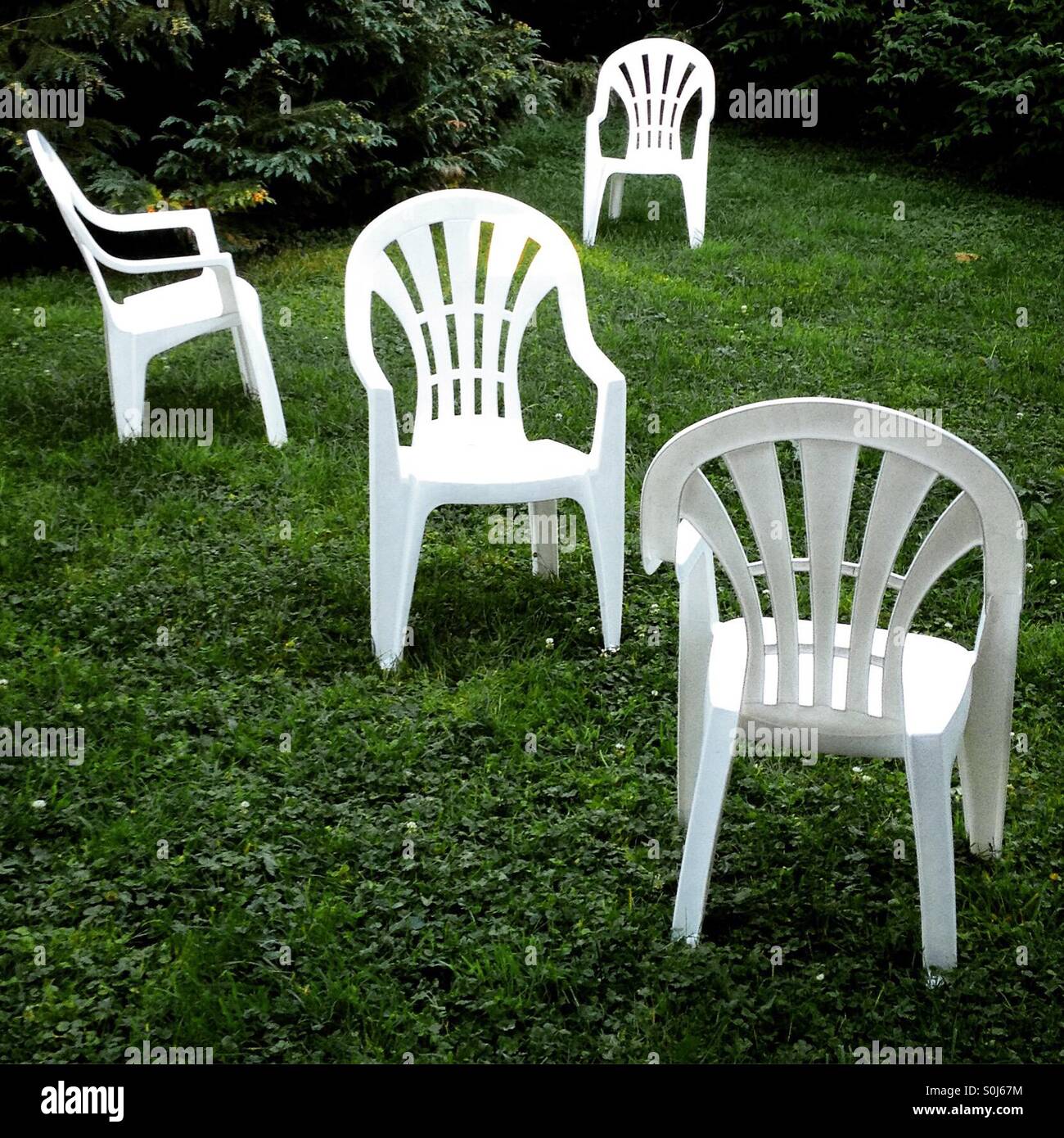 Plastic garden chairs left randomly. Mobile phone photo with some phone or tablet post processing. - Smartphone Captured Stock Image