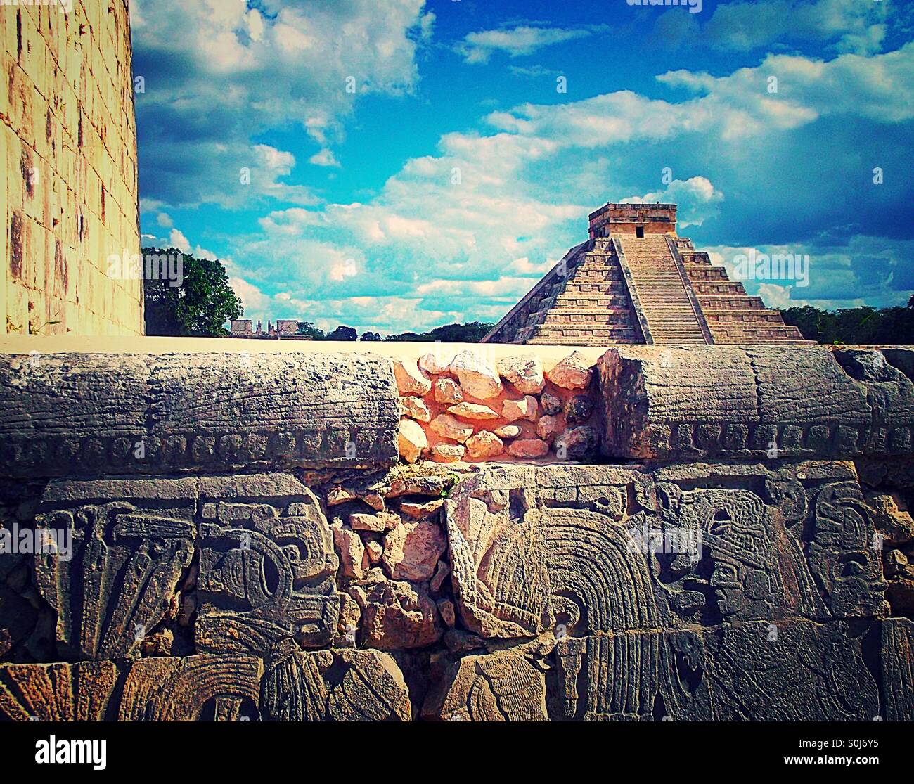 Mayan inscriptions with main Chichen Itza pyramid in background Mexico - Smartphone Captured Stock Image